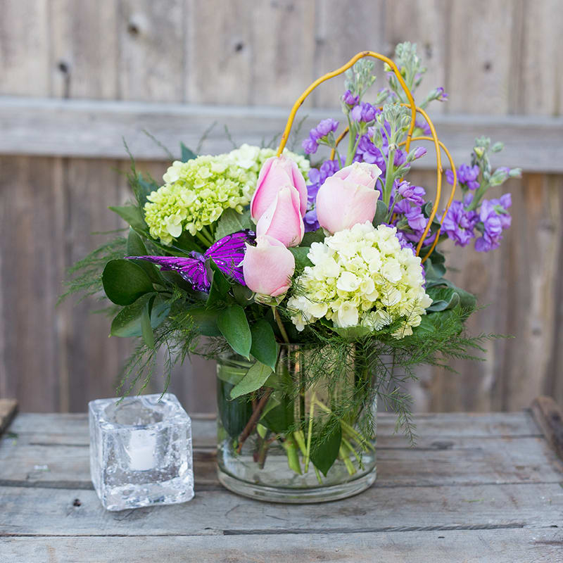 Spring Treasure #111 Spring Treasure #111 - A delightful vase arrangement that captures the feel of the spring garden. Green hydrangea, pink roses and stock with a butterfly dancing over it.