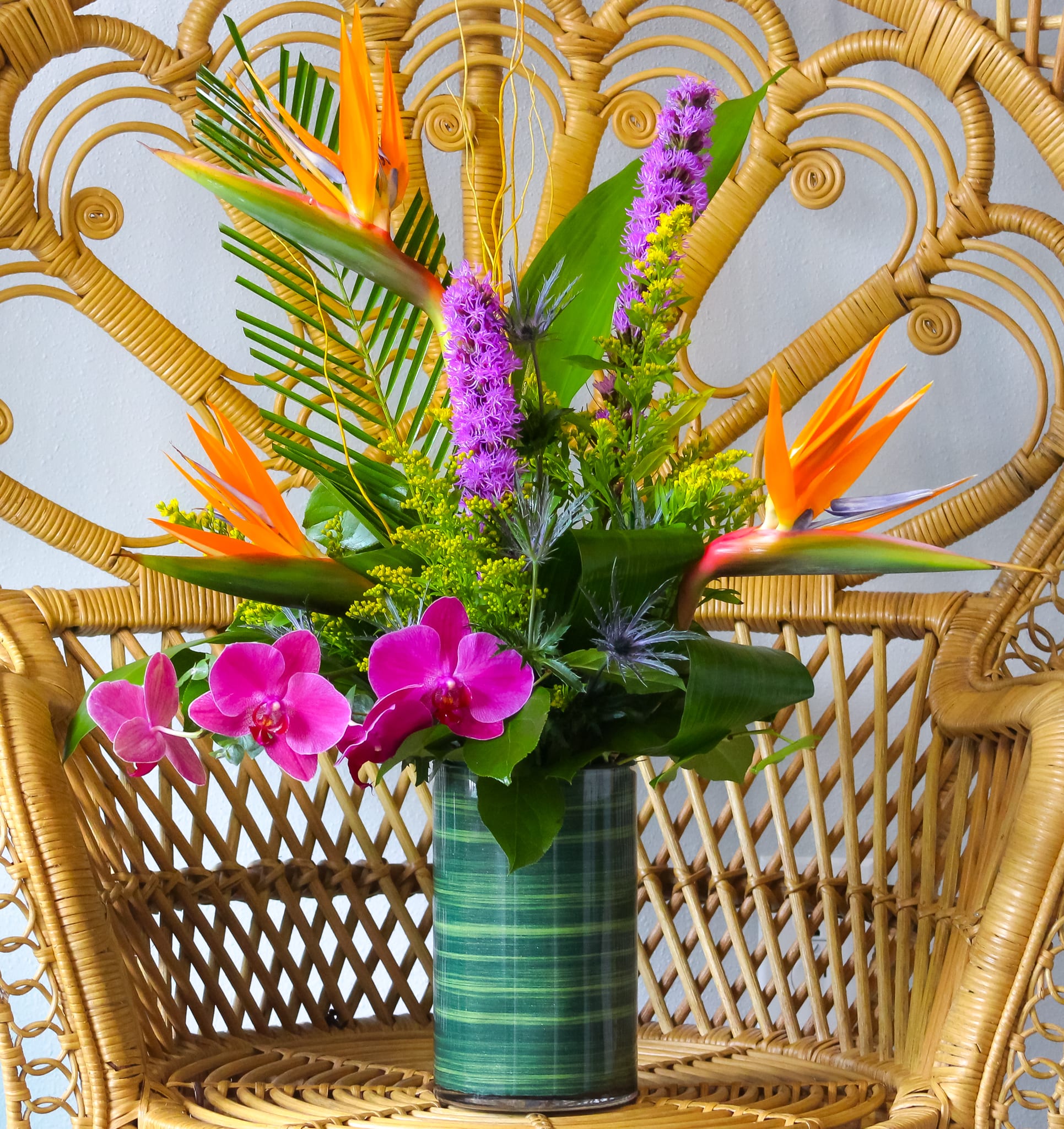 Tropics  Tropics  - This arrangement includes birds of paradise, liatris, solidago, blue thistle, and tropical leaves.