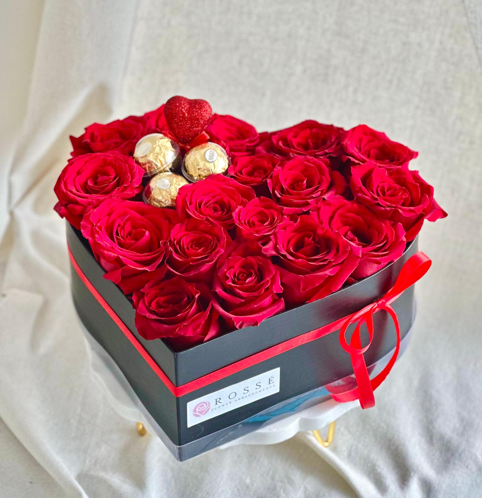 Rose and Sweet Love in Red  - A heart-shaped black box with roses and chocolates, presented as a gift set.   Flower types may vary depending on the season.