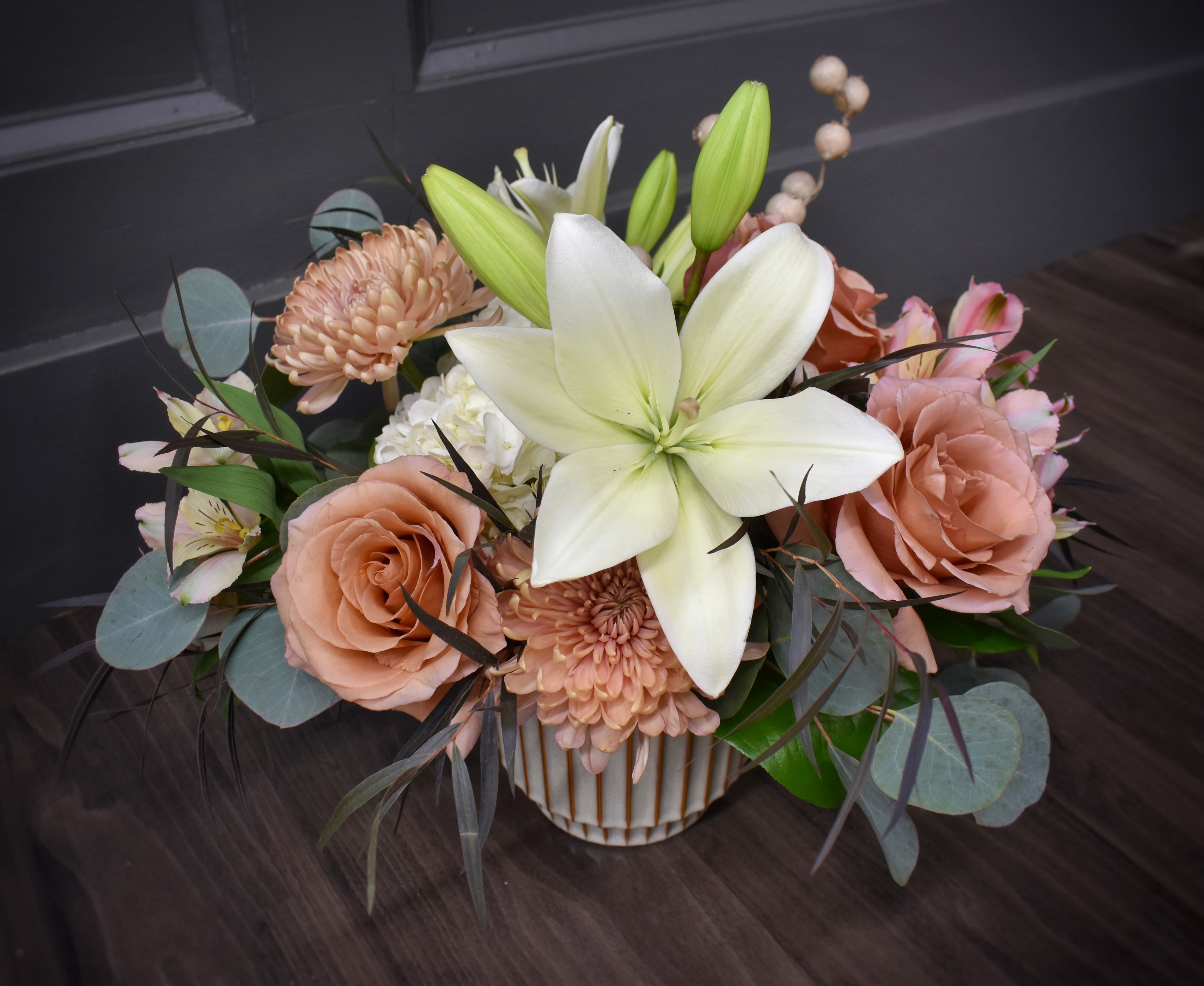Premiere Cashmere - Pastel pinks with a touch of white and burgundy and a sprig of everlasting taupe berries. This is our premium edition, which features additional lilies and alstromeria. 