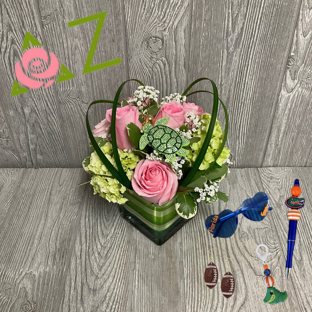 Delta Zeta Gift Set Delta Zeta Gift Set - Delta Zeta Gift Set! Perfect for your Delta Zeta daughter or sister.  Included in Gift Set -Floral Arrangement -Rhinestone Turtle Keychain -1 Pair of Rhinestone Football Earrings -1 Assorted Gator Pen -1 Pair of Assorted Gator Sunglasses -1 Assorted Gator Keychain
