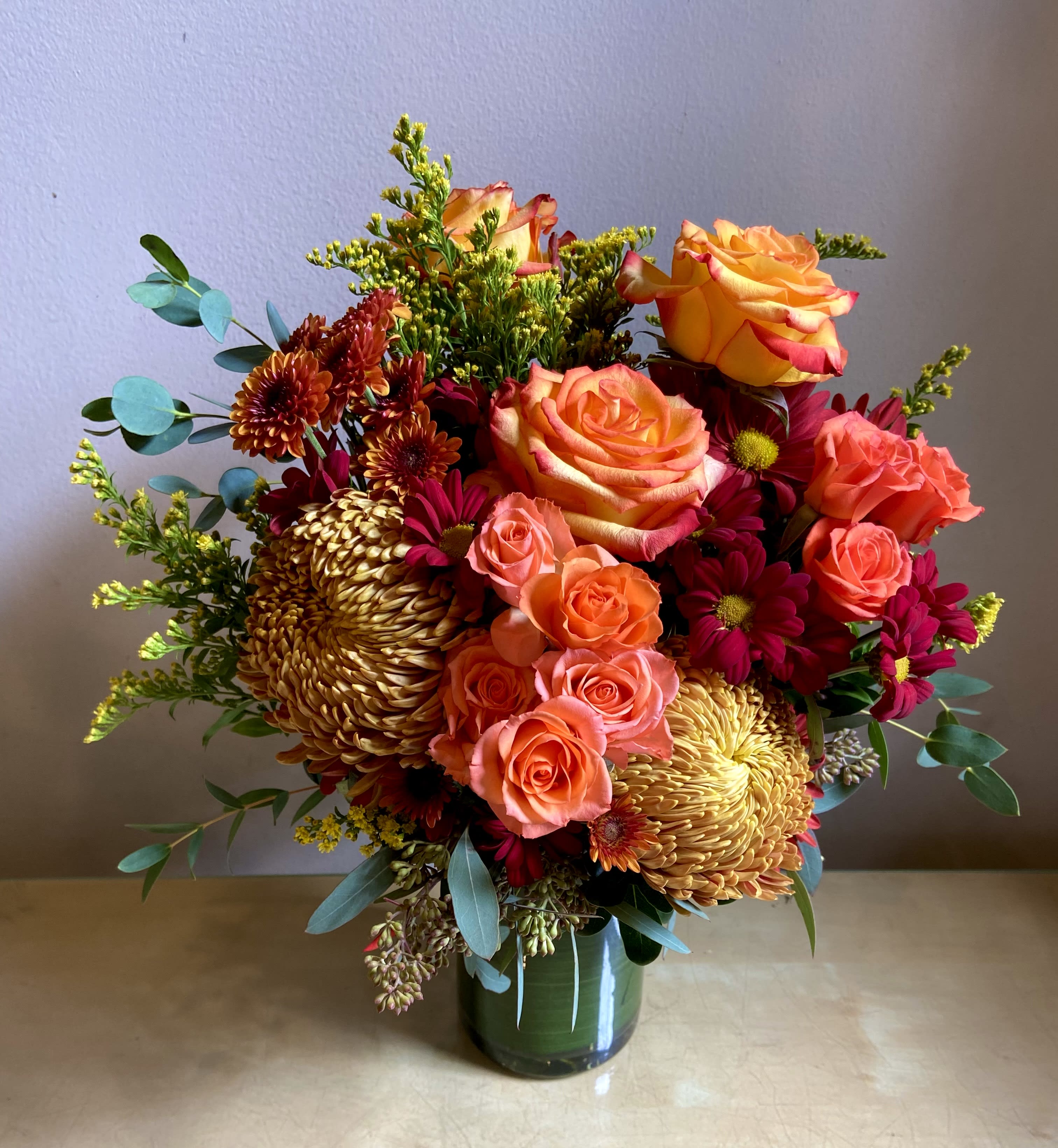 Autumn Joy - Bright &amp; beautiful fall arrangement is sure to bring joy to your day. 12-15&quot; tall with roses, spray roses, chrysanthemums, solidago &amp; fall foliage.