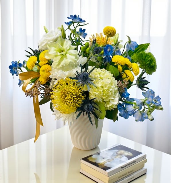 Luna &amp; Sol  - A modern blend of white, yellow, and blue blooms — effortlessly elegant and versatile for any occasion. Luna &amp; Sol embodies balance and beauty, radiating warmth, serenity, and timeless sophistication in every setting.