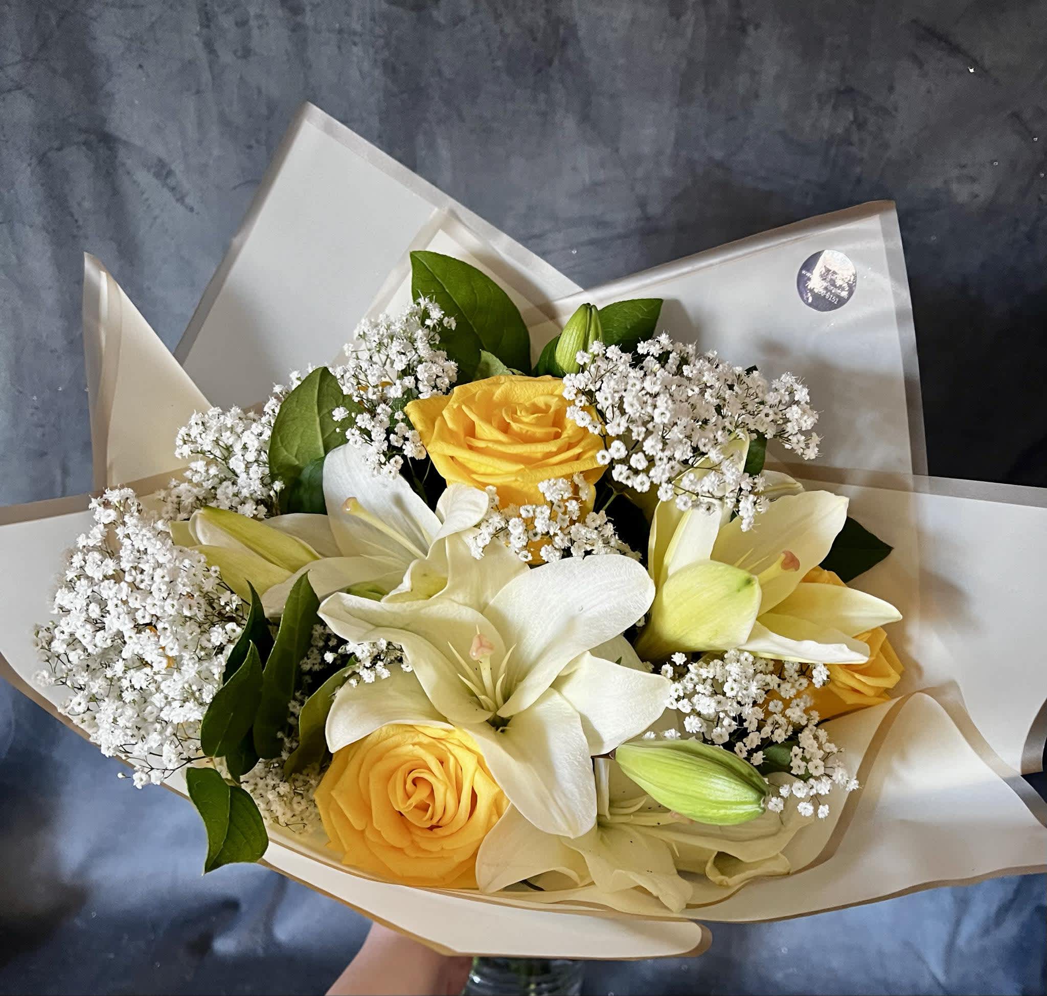 White Yellow Blooms Bouquet  - introducing Our New Design White Yellow Blooms hand tied bouquet, beautifully arranged with , white lilies, yellow roses fillers and greenery.  It doesn't come with a vase. 