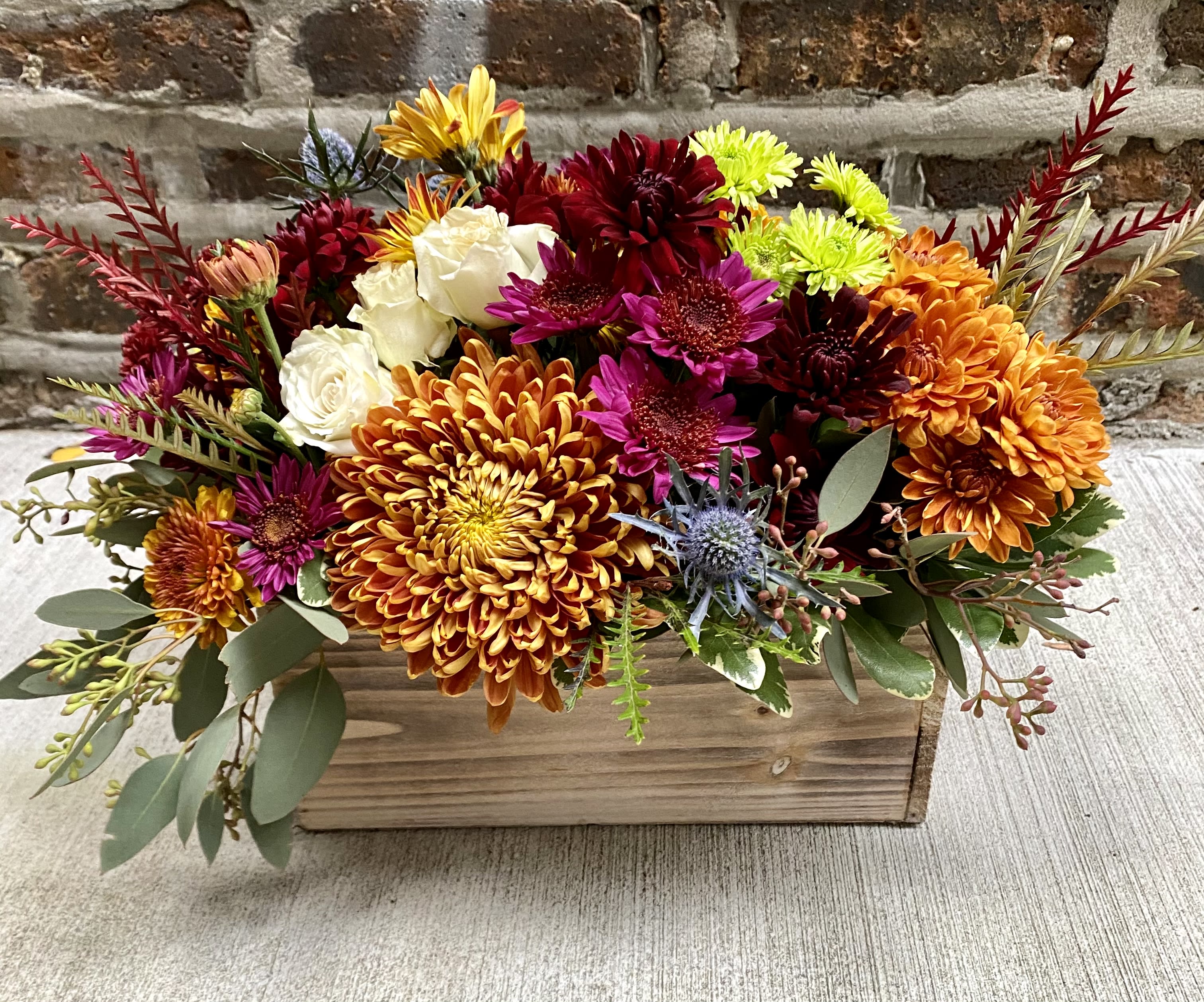 Hearty ALL MUM Floral Box Hearty ALL MUM Floral Box - long and narrow floral arrangement of hearty long lasting mums and accent florals that will last up to 10 days with watering.
