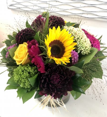 Thankful Thankful - A cheerful blend of yellow, pink and burgundy blooms arranged with greenery into a glass vase.