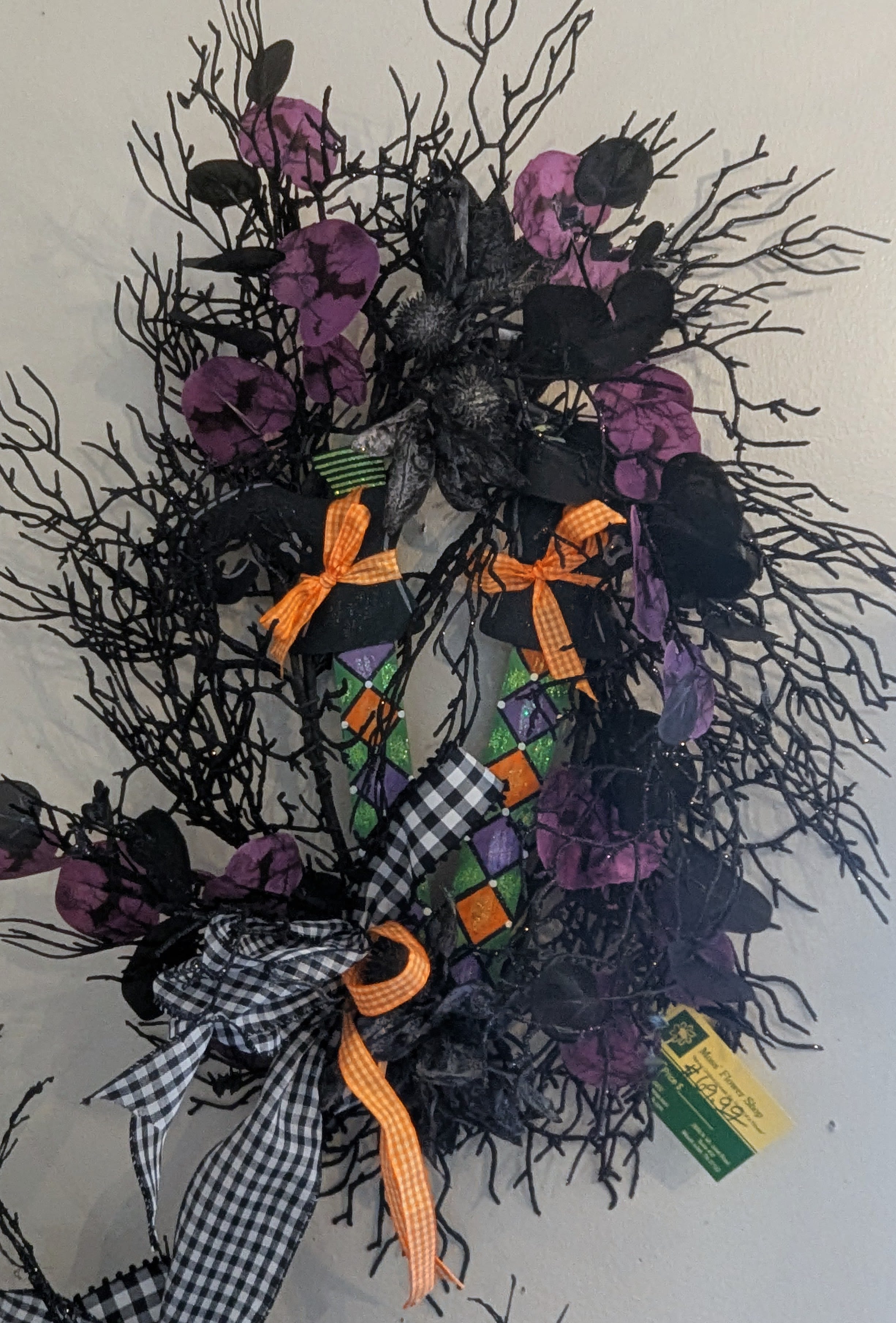 Spooky Chic Halloween Wreath Spooky Chic Halloween Wreath - Transform your home into a haunted haven with our Spooky Chic Halloween Wreath. Crafted from faux black branches, this eerie yet stylish wreath sets the perfect spooky scene for your Halloween festivities. Adorned with a bow and whimsical metal witch's legs, this decoration is sure to captivate and charm all your guests.