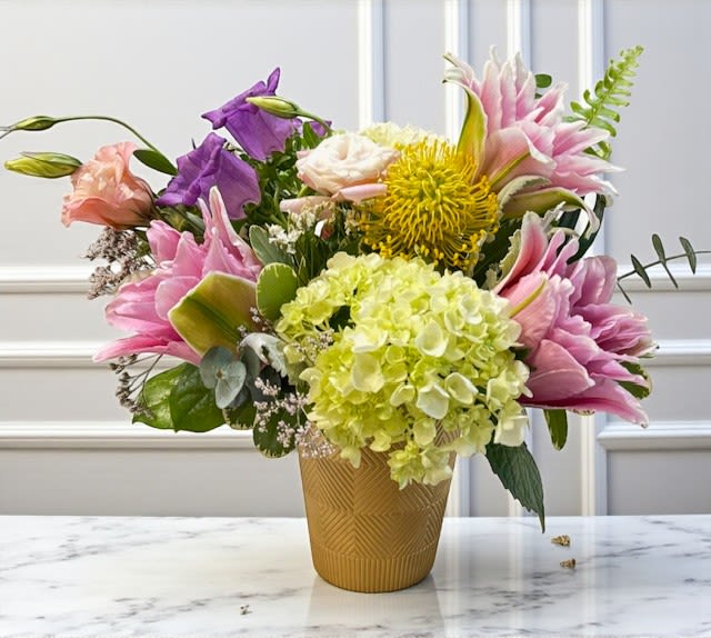 Baby Doll Baby Doll - Soft, sweet, and full of charm — Baby Doll is a delicate mix of pink and lavender tones designed to celebrate life’s tender moments. Whether welcoming a new baby girl or expressing love and affection, this arrangement radiates warmth, joy, and feminine grace in every bloom.