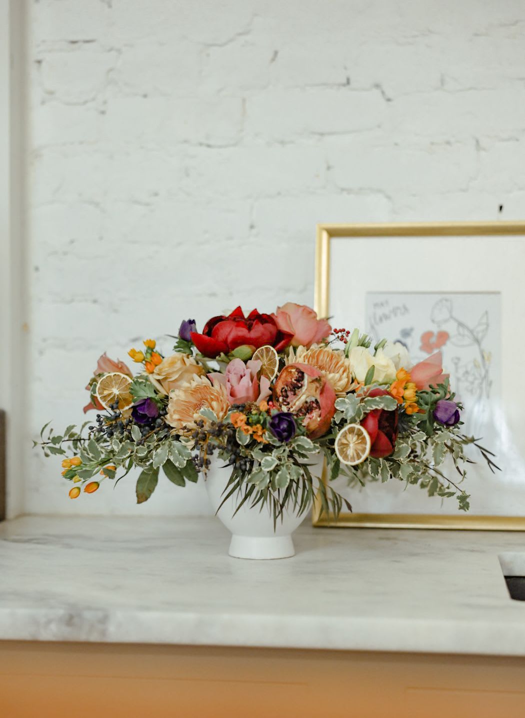 A Bowl of Oranges A Bowl of Oranges - A lush and unique arrangement with berries, dried fruit, garden roses, muted tones and pops of vibrant color. A truly stunning arrangement delivered in compote style vase.   *Please note that substitutions often need to be made due to seasonality and availability (especially in same day orders), but the quality, style, and overall feel of the arrangement will remain the same.