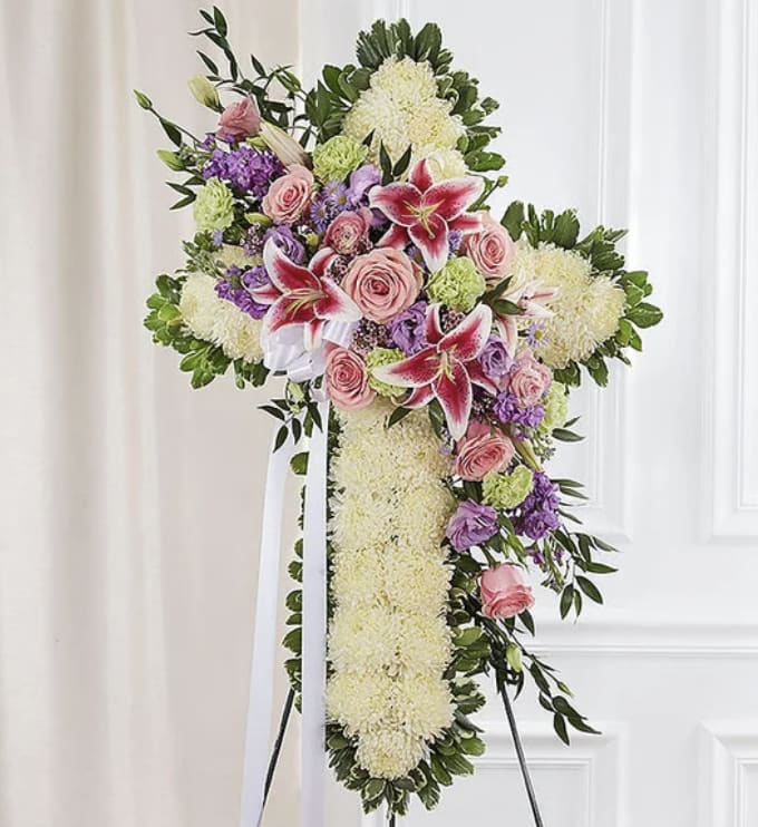 Faithful Tribute - Faithful Tribute – Standing Cross Floral Arrangement ️  Honor and celebrate a life of faith with our Faithful Tribute Cross, a stunning floral arrangement featuring a cross of pure white chrysanthemums, accented with soft pink roses, vibrant stargazer lilies, lavender blooms, and fresh greenery. This beautiful tribute serves as a heartfelt symbol of love, hope, and remembrance.   Why Choose This Tribute?  Premium Fresh Flowers – A serene and elegant floral arrangement  Symbol of Faith &amp; Comfort – A beautiful expression of love and devotion  Perfect for Funerals &amp; Memorial Services – A meaningful way to pay respects  Fast &amp; Reliable Delivery – Ensuring a seamless experience during difficult times 