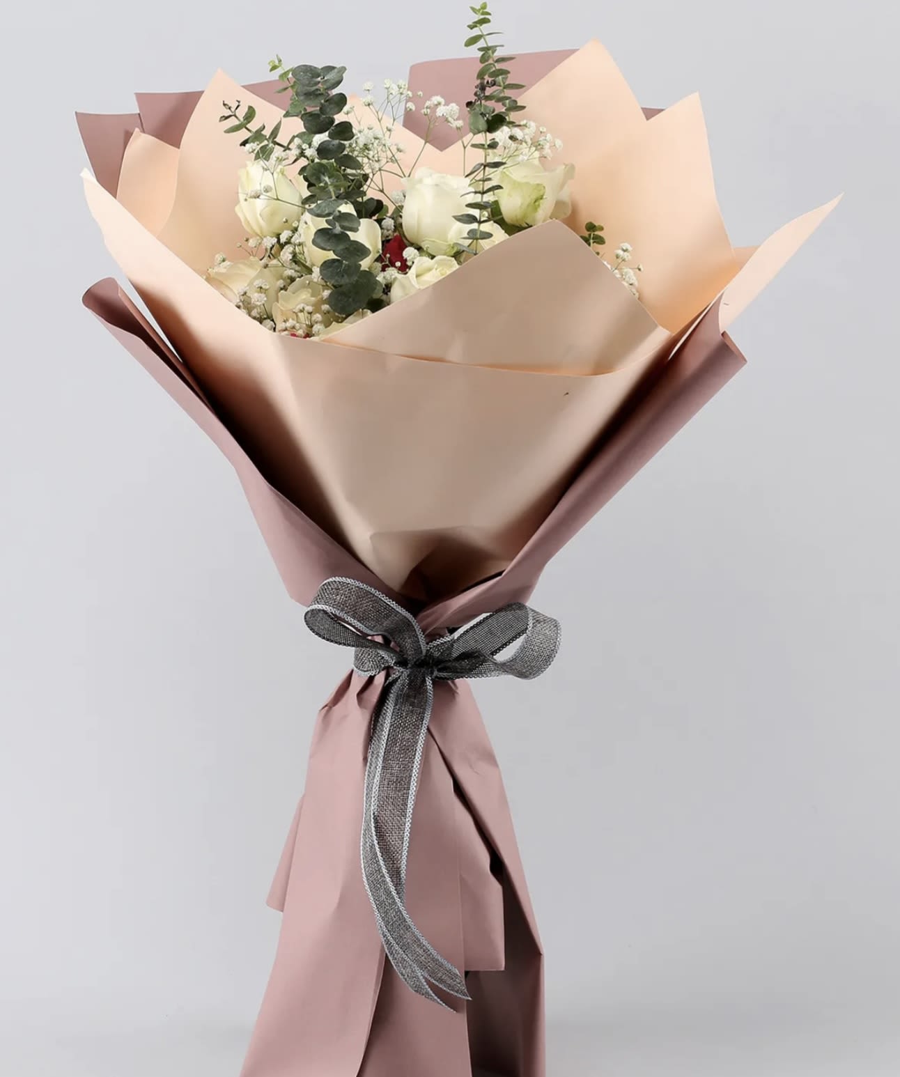 Mom Flower - Elevate any occasion with our Elegant White Rose Bouquet. Featuring fresh white roses accented with delicate baby’s breath and lush eucalyptus, this sophisticated arrangement is wrapped in soft pastel paper and tied with a sleek ribbon for a refined touch. Perfect for weddings, anniversaries, or simply to express your heartfelt sentiments, this bouquet embodies timeless beauty and grace. Order now to make someone’s day unforgettable!