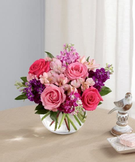 Pink &amp; Purple Floral Arrangement -  Radiant Charm – Pink &amp; Purple Floral Arrangement   Add a touch of elegance and romance to any space with our Radiant Charm Floral Arrangement! Featuring lush pink roses, delicate alstroemeria, vibrant purple stock, and fresh greenery, this stunning bouquet is beautifully arranged in a modern glass vase—perfect for any occasion.   Why You’ll Love It:  Handpicked Fresh Flowers – Long-lasting beauty and fragrance  Elegant &amp; Stylish Design – A perfect blend of pinks and purples  Ideal for Every Occasion – Birthdays, anniversaries, celebrations, or a heartfelt gift  Fast &amp; Reliable Delivery – Order online and send love effortlessly   Shop now &amp; brighten someone’s day with floral elegance!