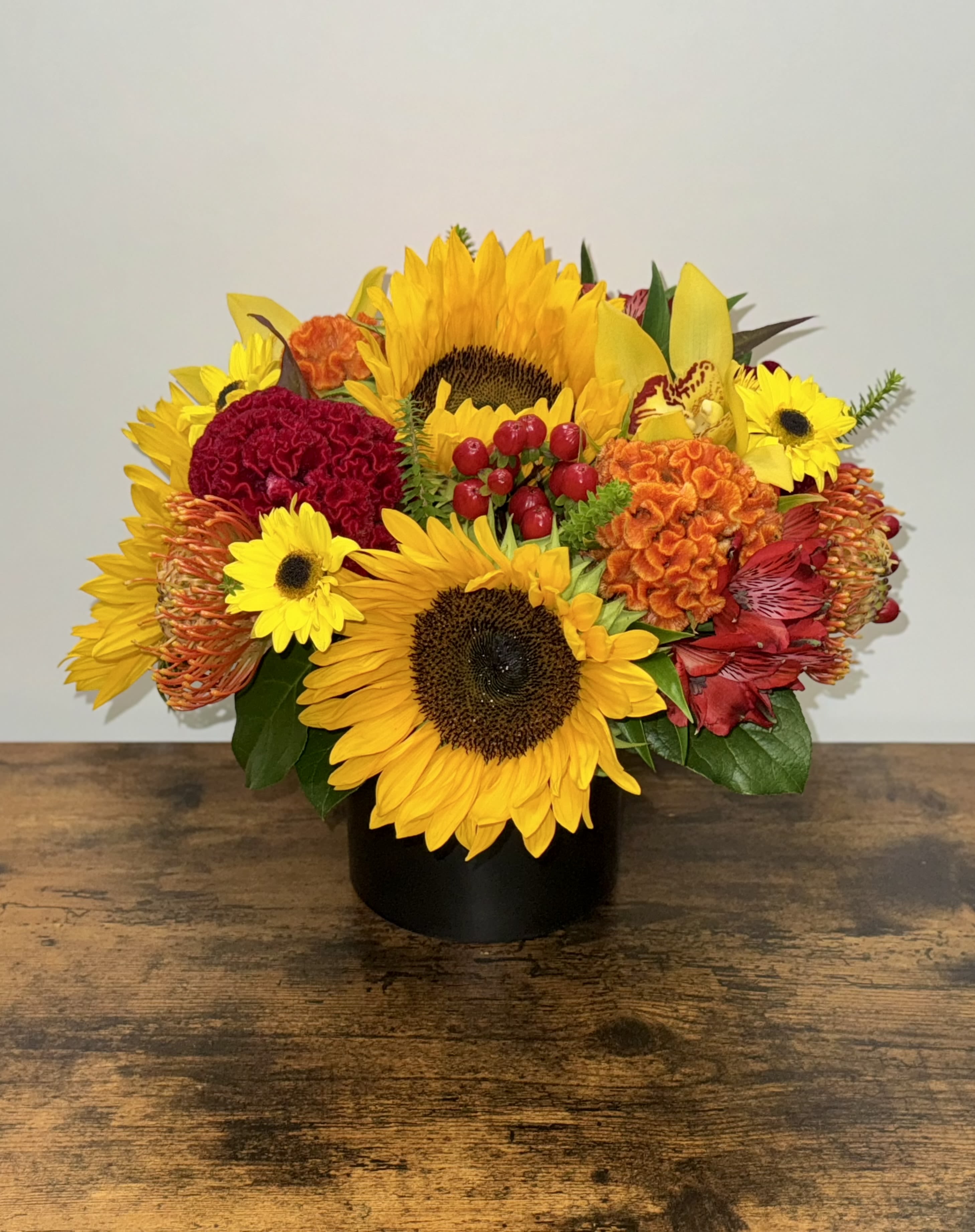 Happy Harvest  - Autumn colors and vibes this arrangement is in a black cylinder with a mix of fall colors and seasonal flowers