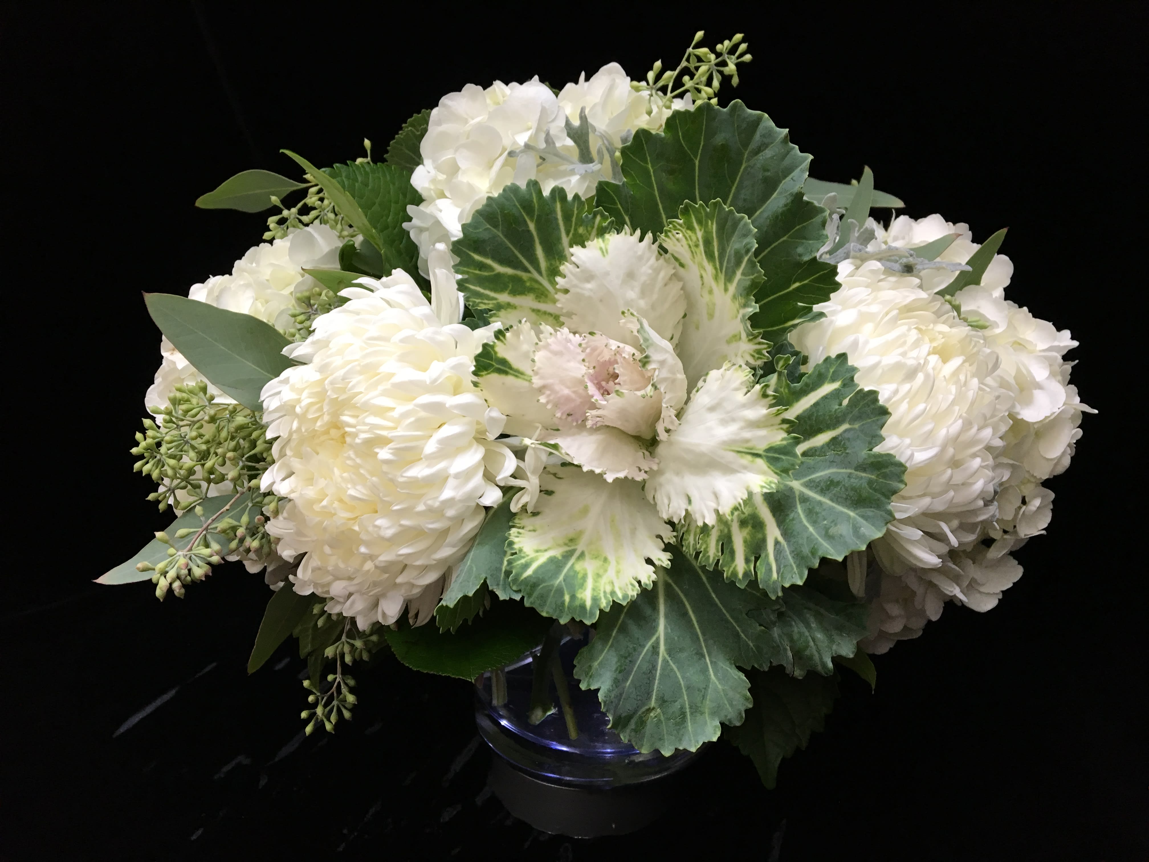 Elegant Autumn Elegant Autumn - Fluffy over sized mums are perfectly paired with seasonal kale, white hydrangea and delicate eucalyptus berries. Definitely the most bang for the buck!
