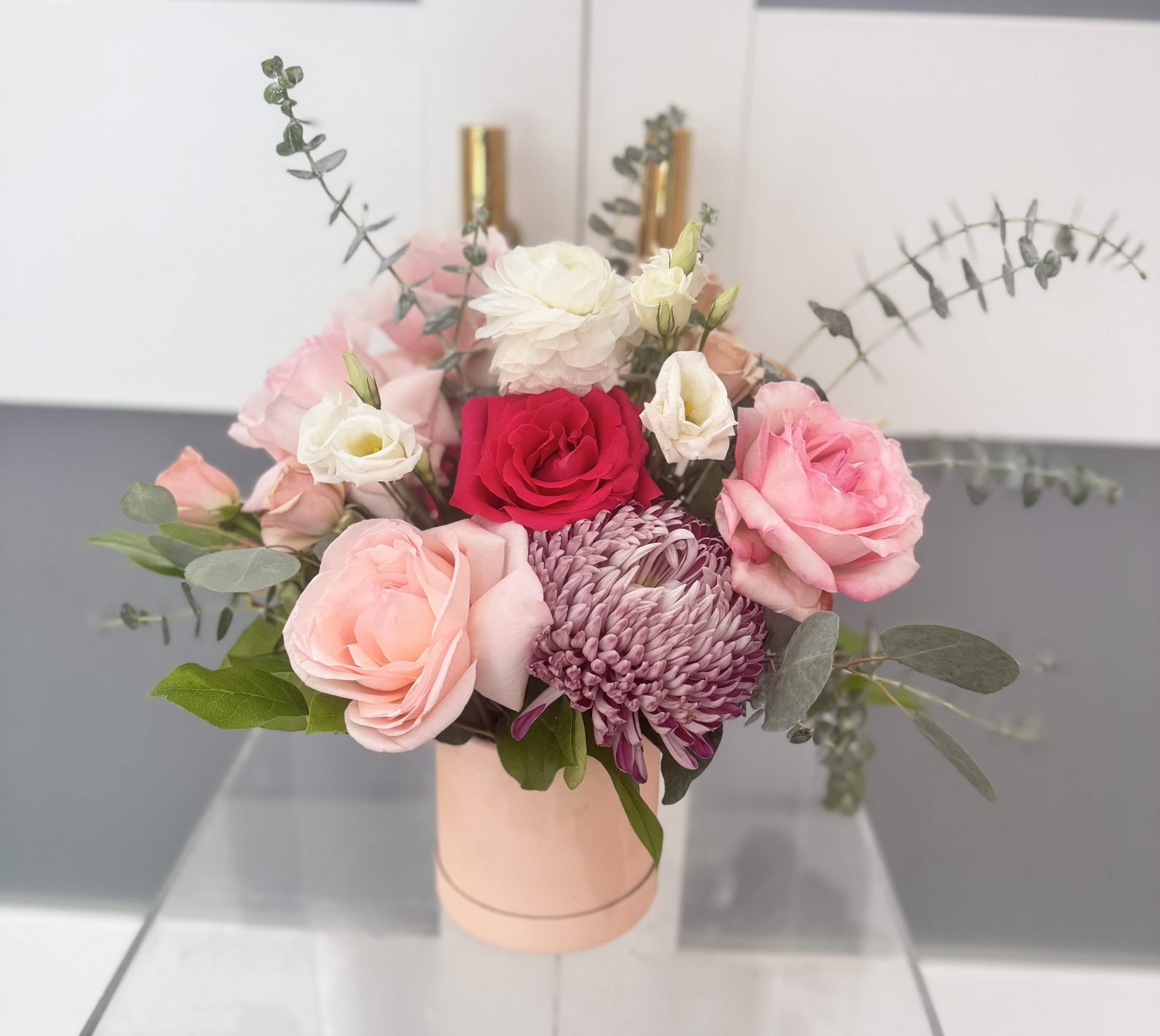 Petite Floral Box - A smaller version our signature floral boxes. The &quot;Petite Floral Box&quot; is the sweetest gift for any occasion.  A stunning composition of premium roses, ranunculus, Cremons, Eucalyptus, and seasonal floral accents.  Each petite box is uniquely designed, ensuring every arrangement is one of a kind. It can be customized to any color upon request and availability.  If no color is requested, it will be designer's choice.