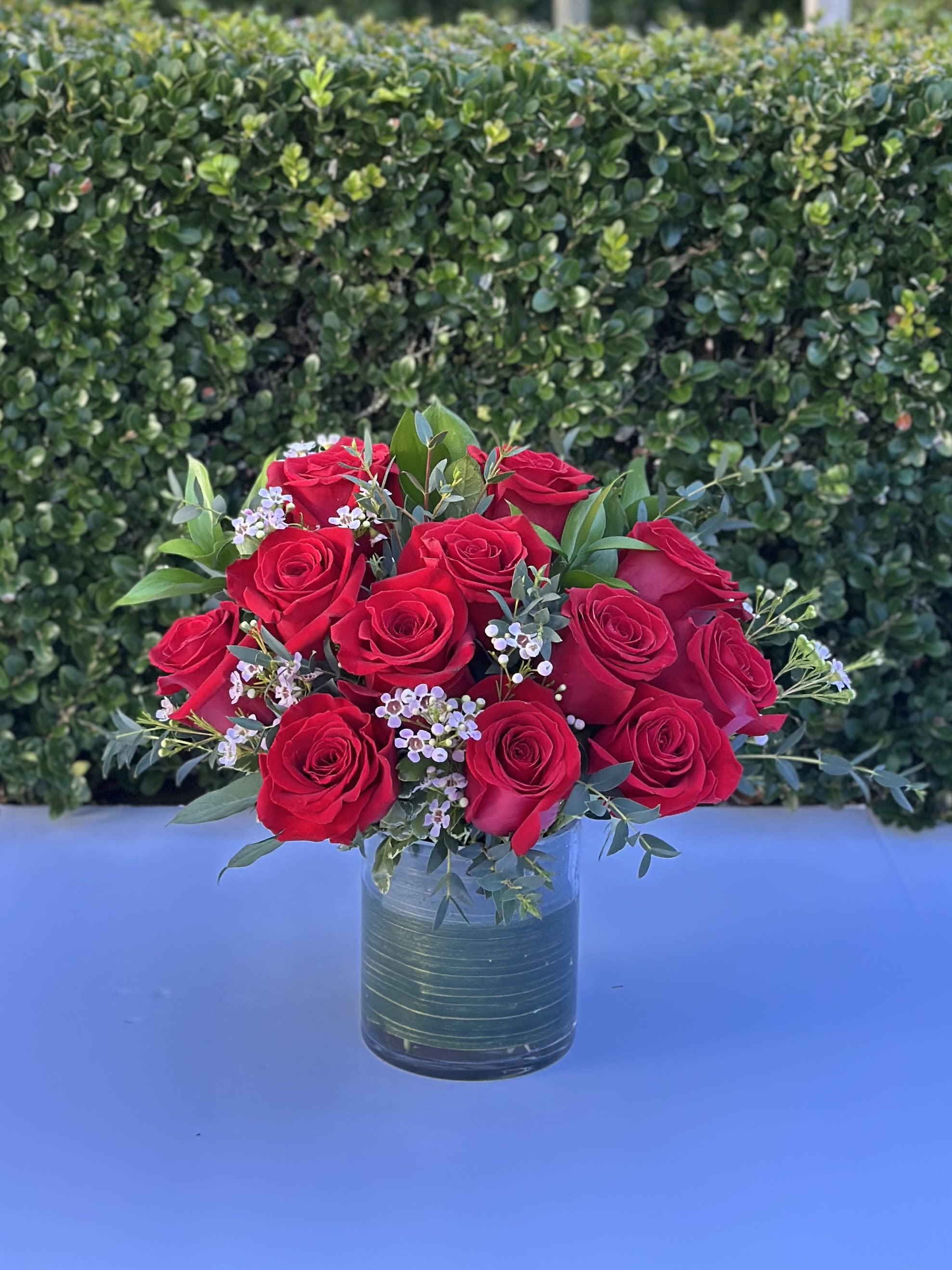 Romance & Red Roses Romance & Red Roses - Make your sweetheart smile with this modern take on classic red roses. 12, 18, or 24 designed in a low and lush style.