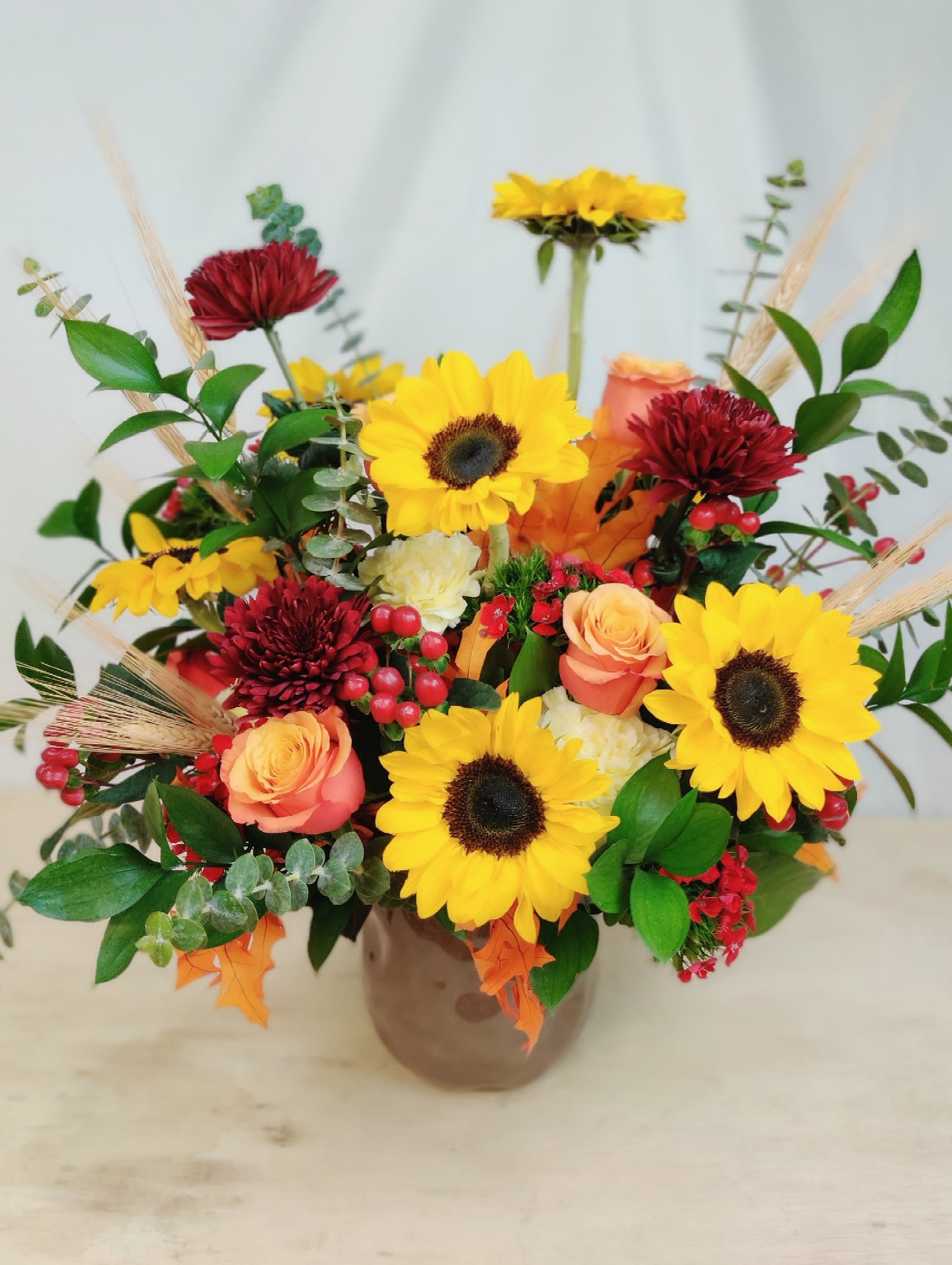 Full Pot of Fall Full Pot of Fall - This fresh flower arrangement of traditional Autumn fall colors will definitely make an impression!! These flowers are completed with touches of wheat and fall leaves.