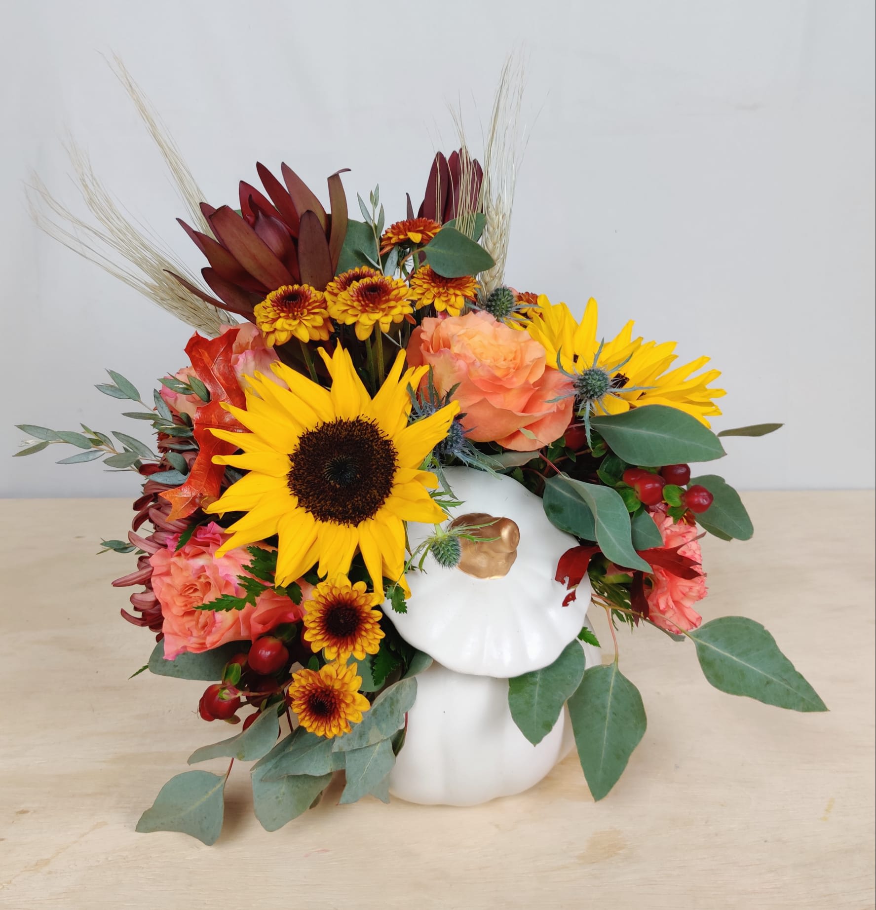White Pumpkin - Ceramic White pumpkin complete with an arrangement of fall seasonal flowers. Perfect for a gift or centerpiece for your holiday table.