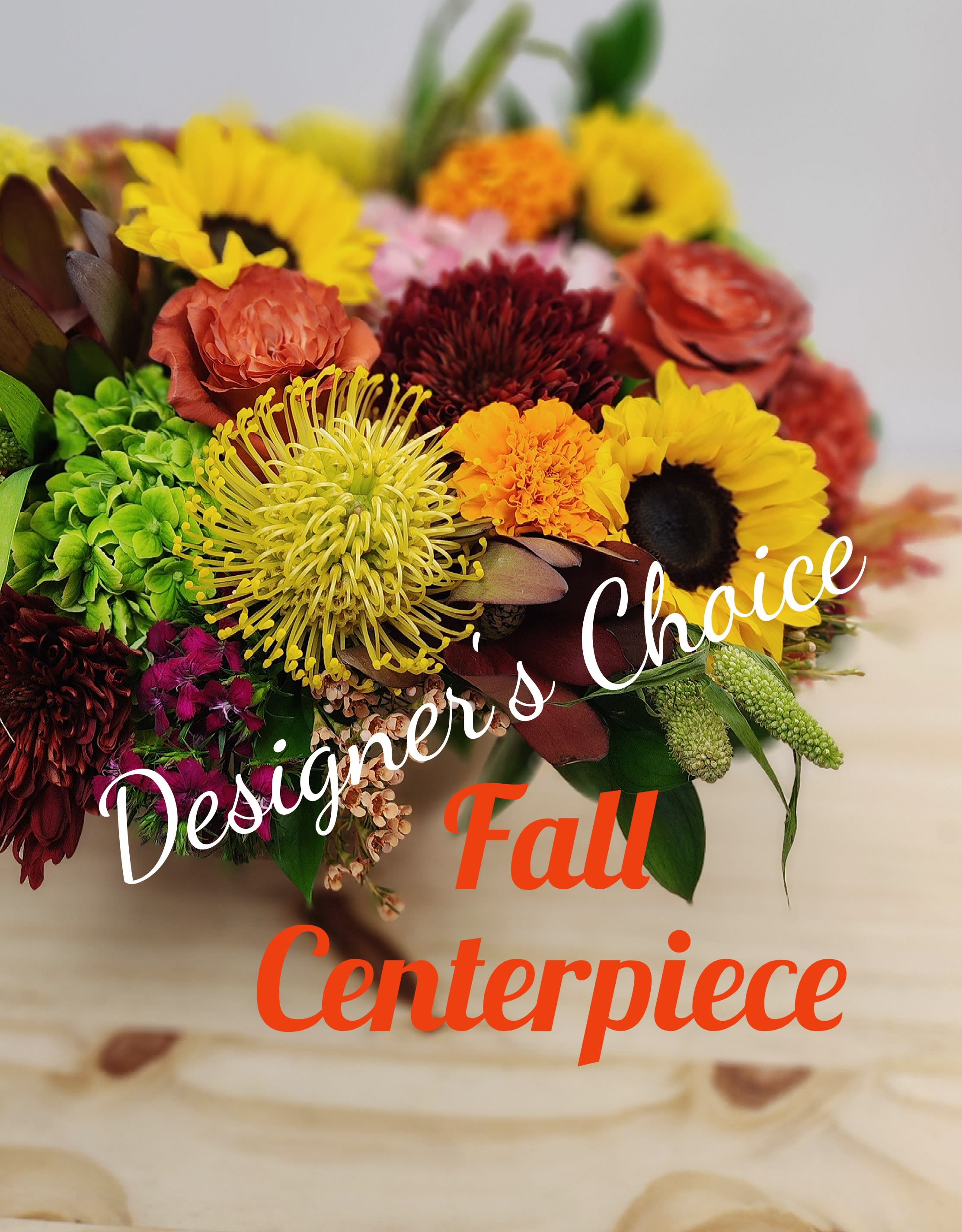 Designer's Choice Fall Centerpiece Designer's Choice Fall Centerpiece - Let out designer's create a one of a kind fresh fall centerpiece for you. This will include assorted seasonal fall tones fresh flowers perfect to complete any table. Flowers and colors may vary from photo. This is a designer's Choice and our seasonal selection changes daily.