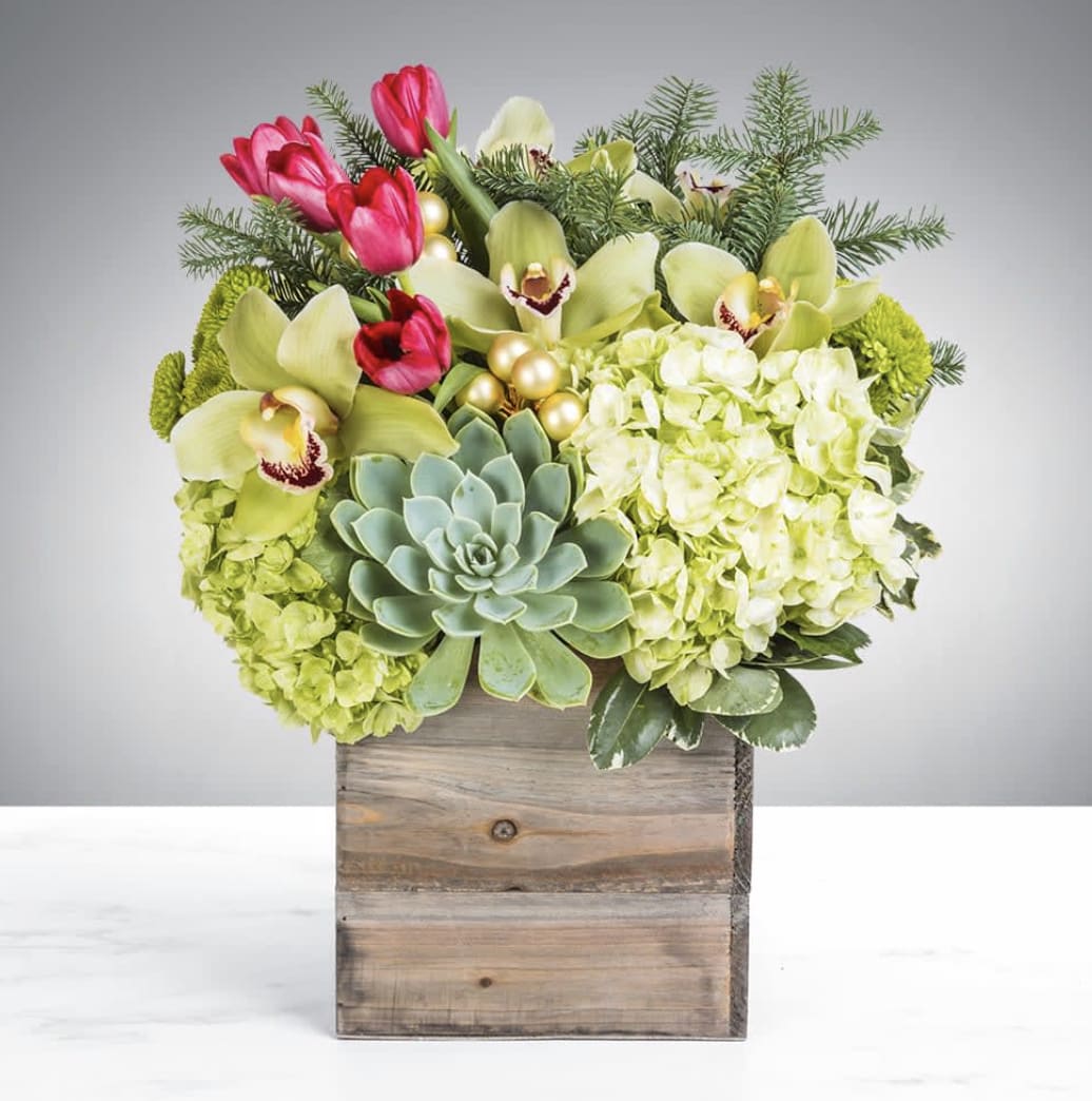 Home for the Holidays Home for the Holidays - You’re going home for the holidays, shouldn’t your flowers get the same courtesy? Introducing Home for the Holidays. Housed in a blissful wooden box, this arrangement is proud to bring its home wherever it goes. Turn your house into a home with this welcoming arrangement.