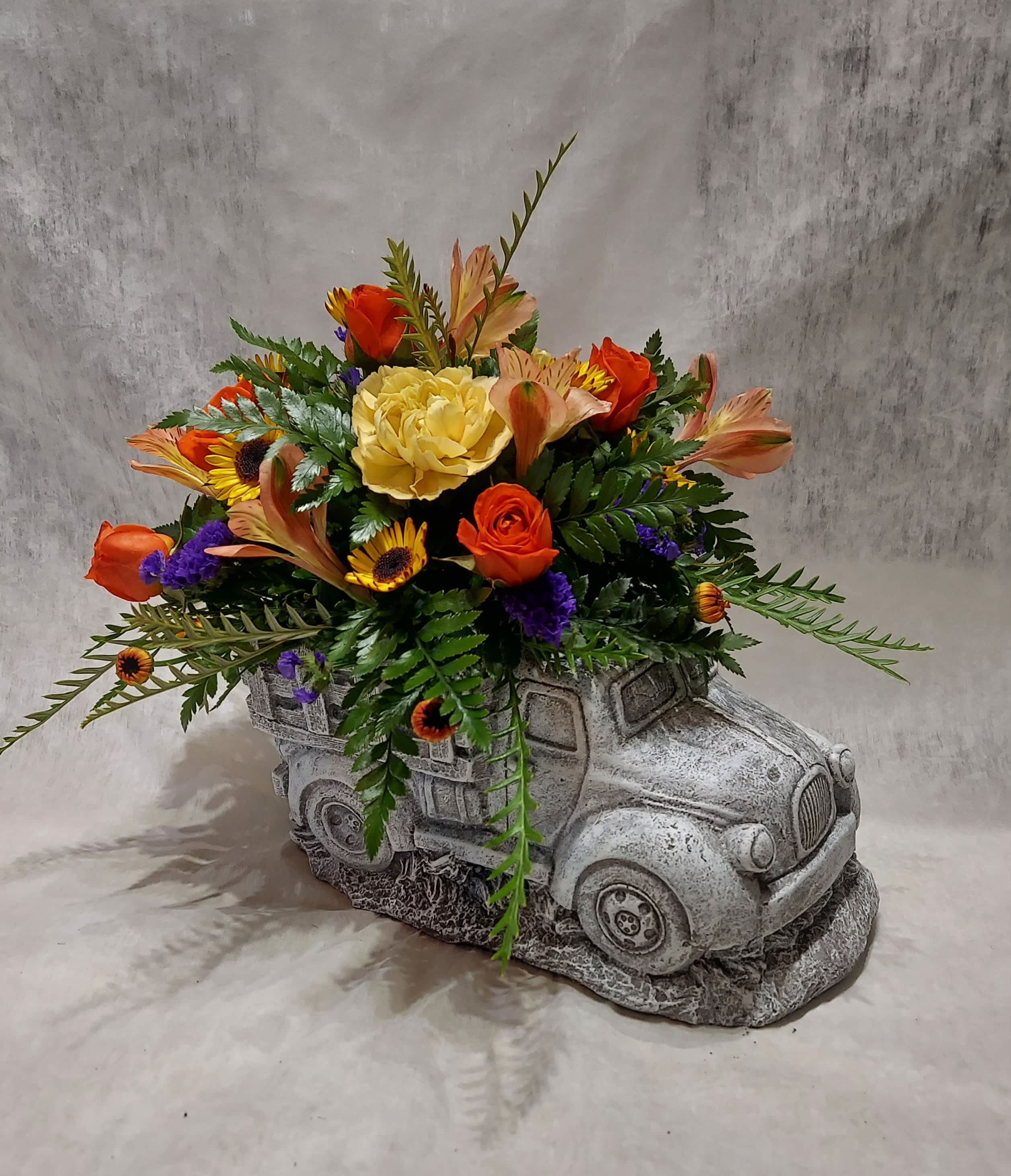 Pick 'Em Up Truck Pick 'Em Up Truck - Our concrete pickup truck has a bed full of colorful flowers! This keepsake is perfect for indoor display or outdoor gardens once the flowers have been enjoyed.  COLORS OF FLOWERS/ TRUCK WILL VARY WITH AVAILABILITY. Approximate size:  9.5"W x 6"H