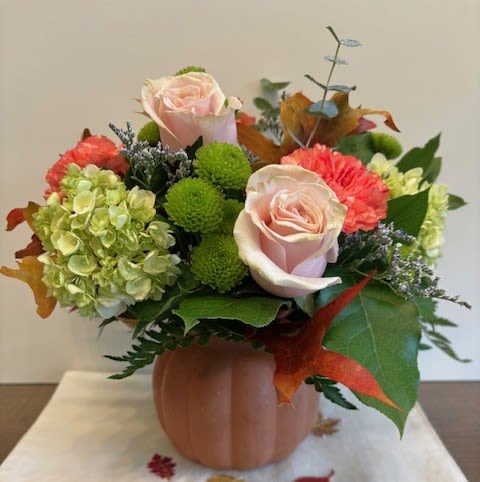 Country Cottage Country Cottage - Gathered blooms of roses, hydrangea and carnations in a glass pumpkin vase adds a country touch to your autumn celebration.