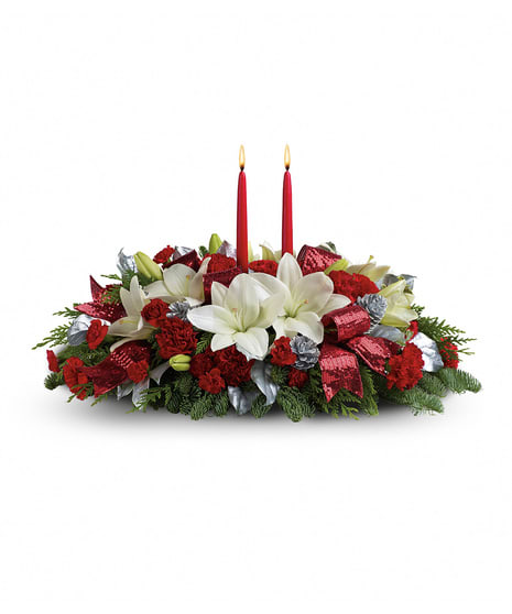 Red and White Holiday Table Centerpiece Red and White Holiday Table Centerpiece - Shiny and bright! Holiday celebrations shine with this lush arrangement of snow white lilies, red roses and red carnations beautifully arranged with fresh holiday greens and decorative pine-cones.