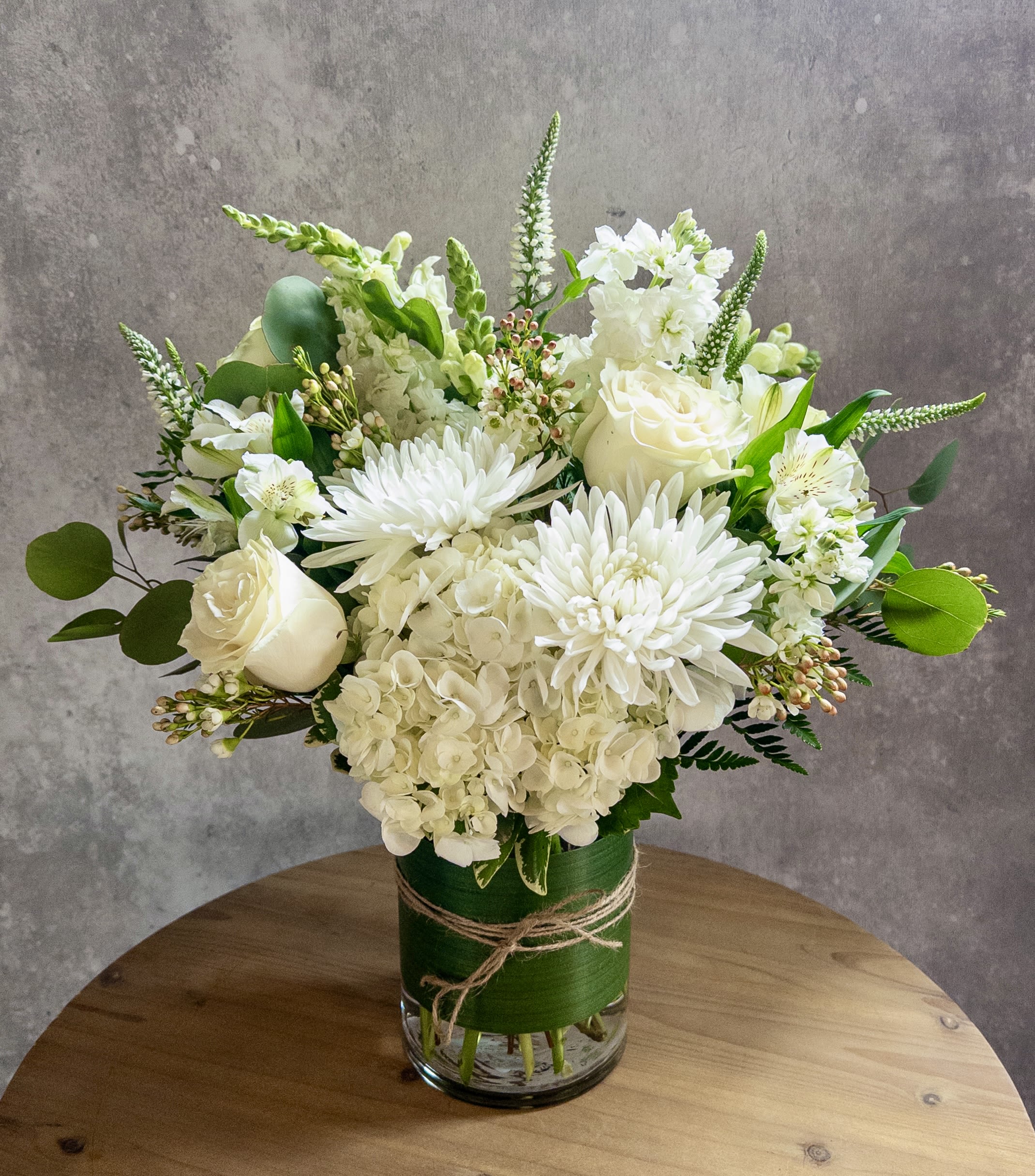 All white classic vase arrangement  - A cylinder vase with all white flowers. To include hydrangeas, snapdragons, white roses, cremons, Veronica and stock. Tall and pretty! 