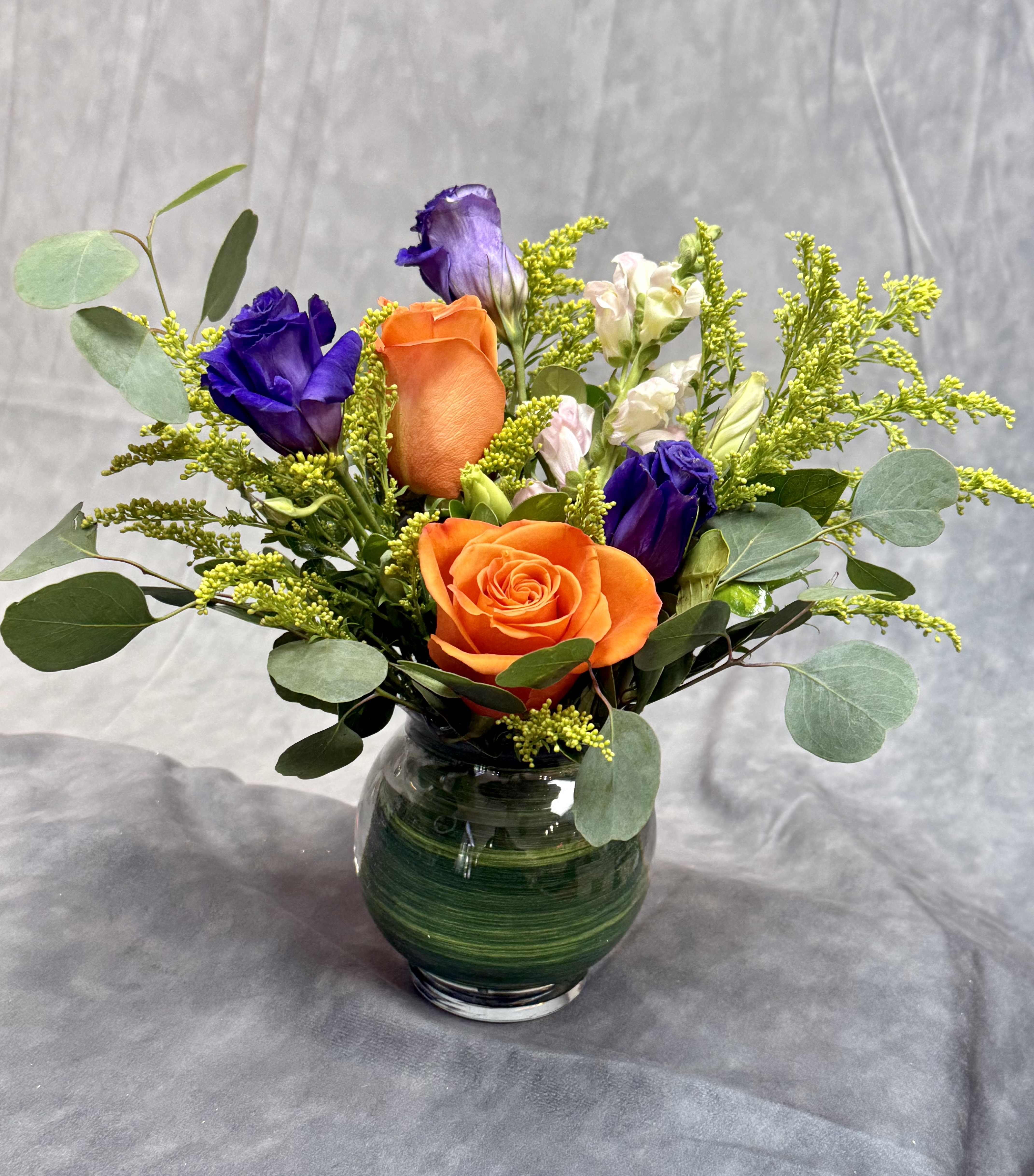 Joyful Hues Vase  - A cheerful burst of color that brightens any space!  Featuring vibrant orange roses, purple lisianthus, and pink snapdragons, this charming arrangement radiates happiness and warmth. Perfect for birthdays, thank-yous, or “just because” moments or event centerpieces — a true celebration of color and joy in every bloom.