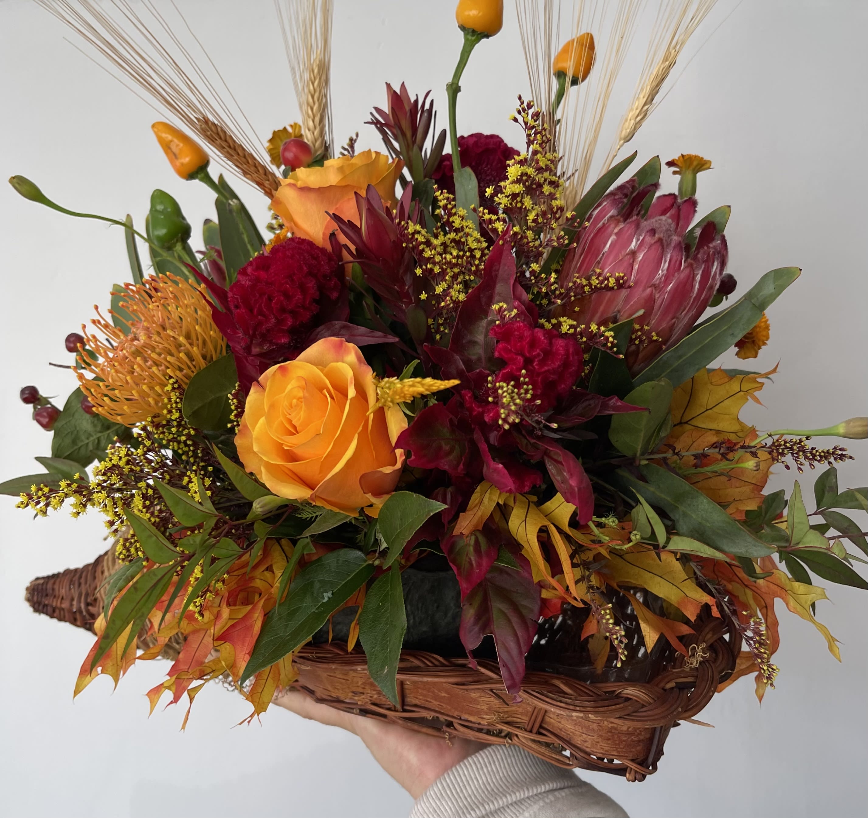 Rustic Cornucopia - Seasonal rustic flowers arranged in a cornucopia. 