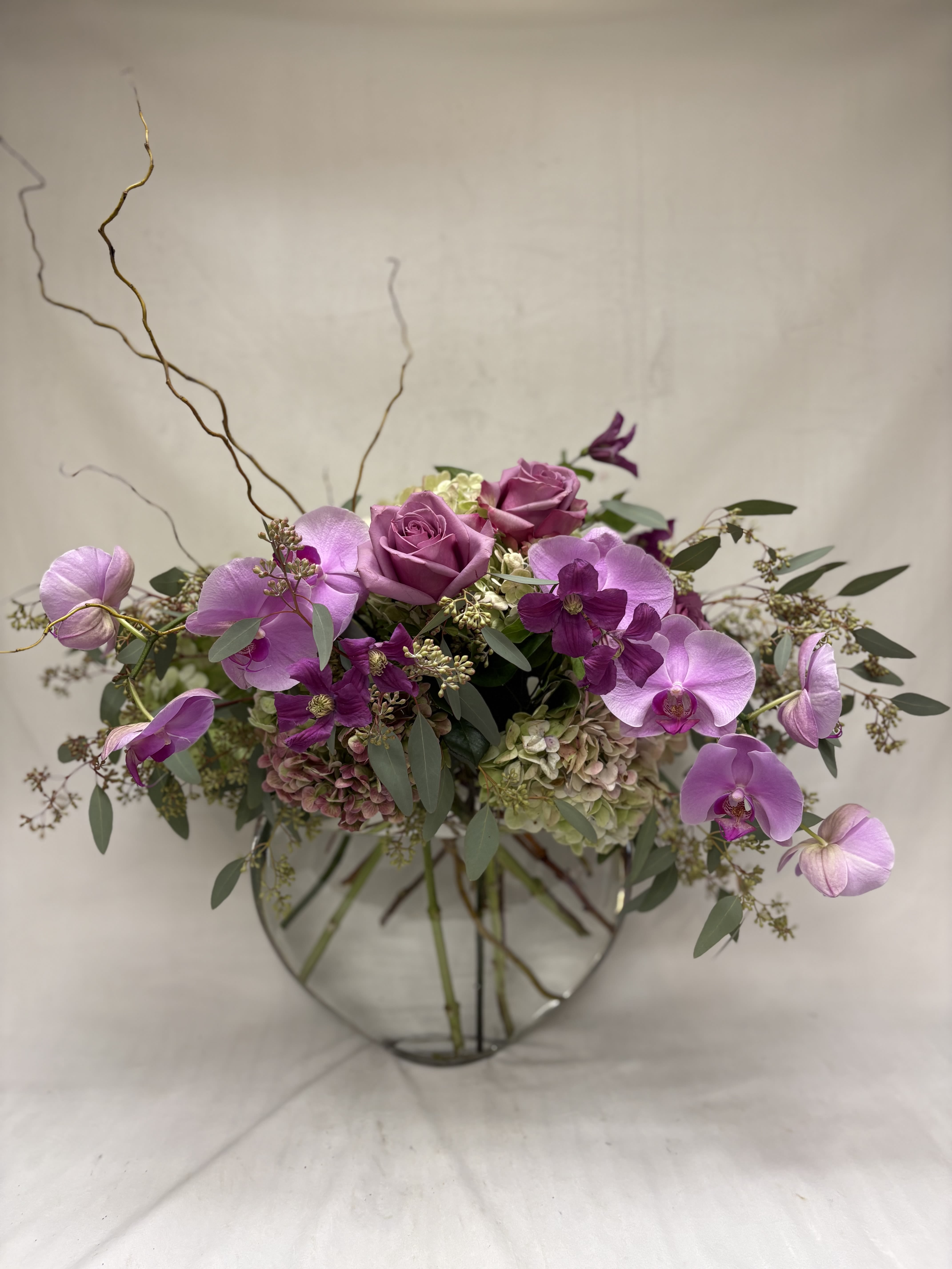 Half Moon Bay - Send a mixture of exquisite orchids roses and antique hydrangea in our moon vase. 