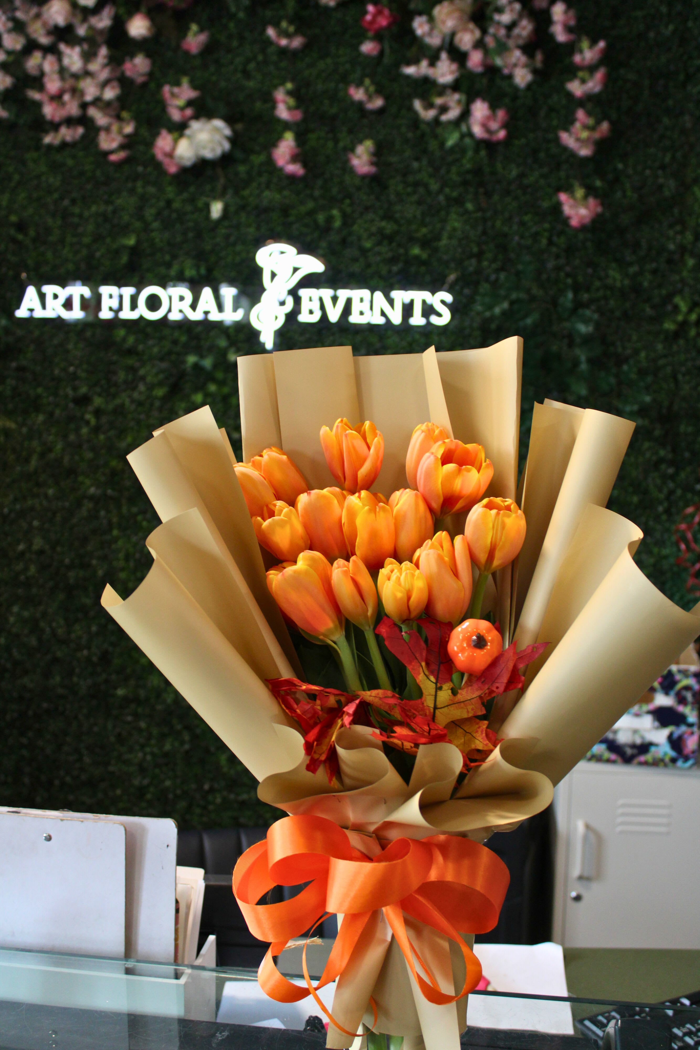 Autumn Tulips - Orange Tulips, Dyed fall leaves, Mini Pumpkin. Wrapped and arranged in a vase.