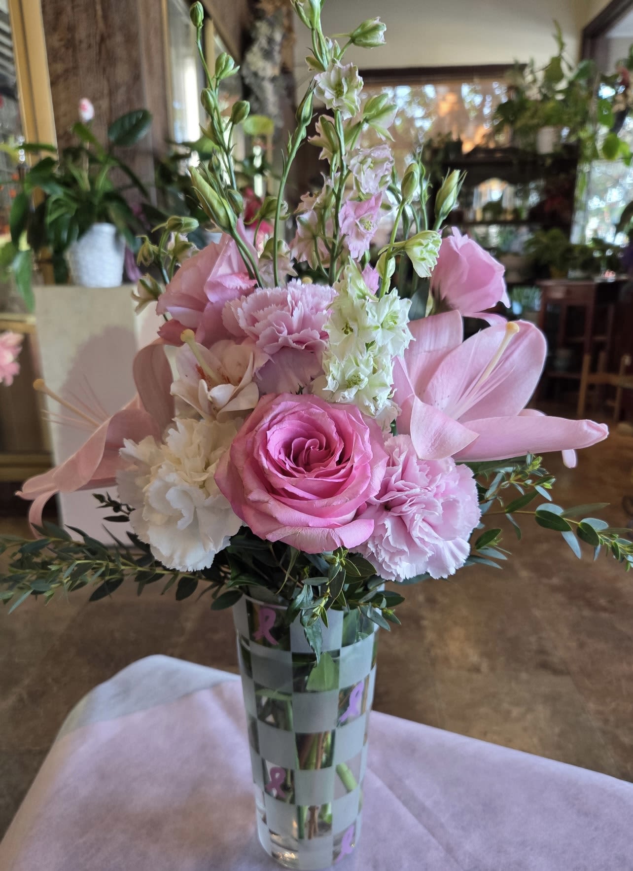 Blush of Bravery Blush of Bravery - Pink and white blooms dedicated to honoring the fighters, survivors, and the loved ones we’ve lost. A soft, elegant reminder that even in the toughest times, beauty and hope continue to bloom.