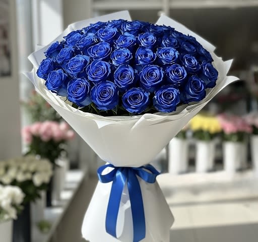 Yemaya By Black Cat Florist - Presenting the “Yemaya” buchon bouquet, a breathtaking and luxurious declaration of love. This stunning bouquet is a masterful arrangement of 50 deep, vibrant blue roses, meticulously placed to form a compact and flawless dome. The rich color of the roses, known for their rarity and symbolic meaning, creates a dramatic and unforgettable visual impact. Presented in elegant, upscale wrapping with a delicate ribbon, the “Yemaya” buchon bouquet is the ultimate expression of passion, devotion, and uniqueness, perfect for honor Yemaya, an anniversary, a grand gesture, or simply to say you are one of a kind.  