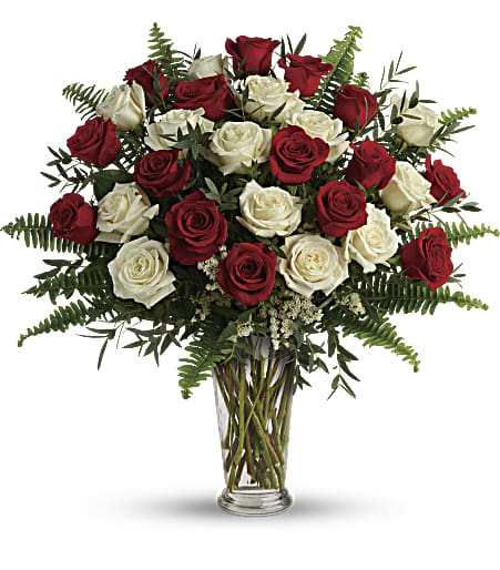 2 Dozen Red and White Roses (DL) - Captivate the heart with our breathtaking arrangement of 24 red and white long stem roses, expertly designed in a chic glass vase. The contrasting colors of these roses symbolize unity and passion, making it a perfect gift for expressing love and devotion.  