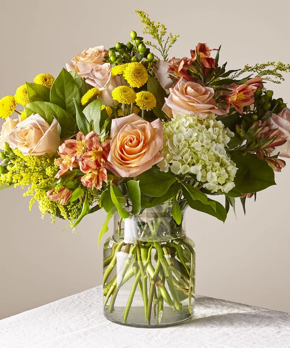Life's a Peach (DL) - Introducing the &quot;Life's a Peach&quot; Thanksgiving Flower Arrangement, a charming and delightful bouquet featuring mini green hydrangeas, pale orange roses, orange alstroemeria, yellow poms, yellow solidago, and green hypericum berries. 