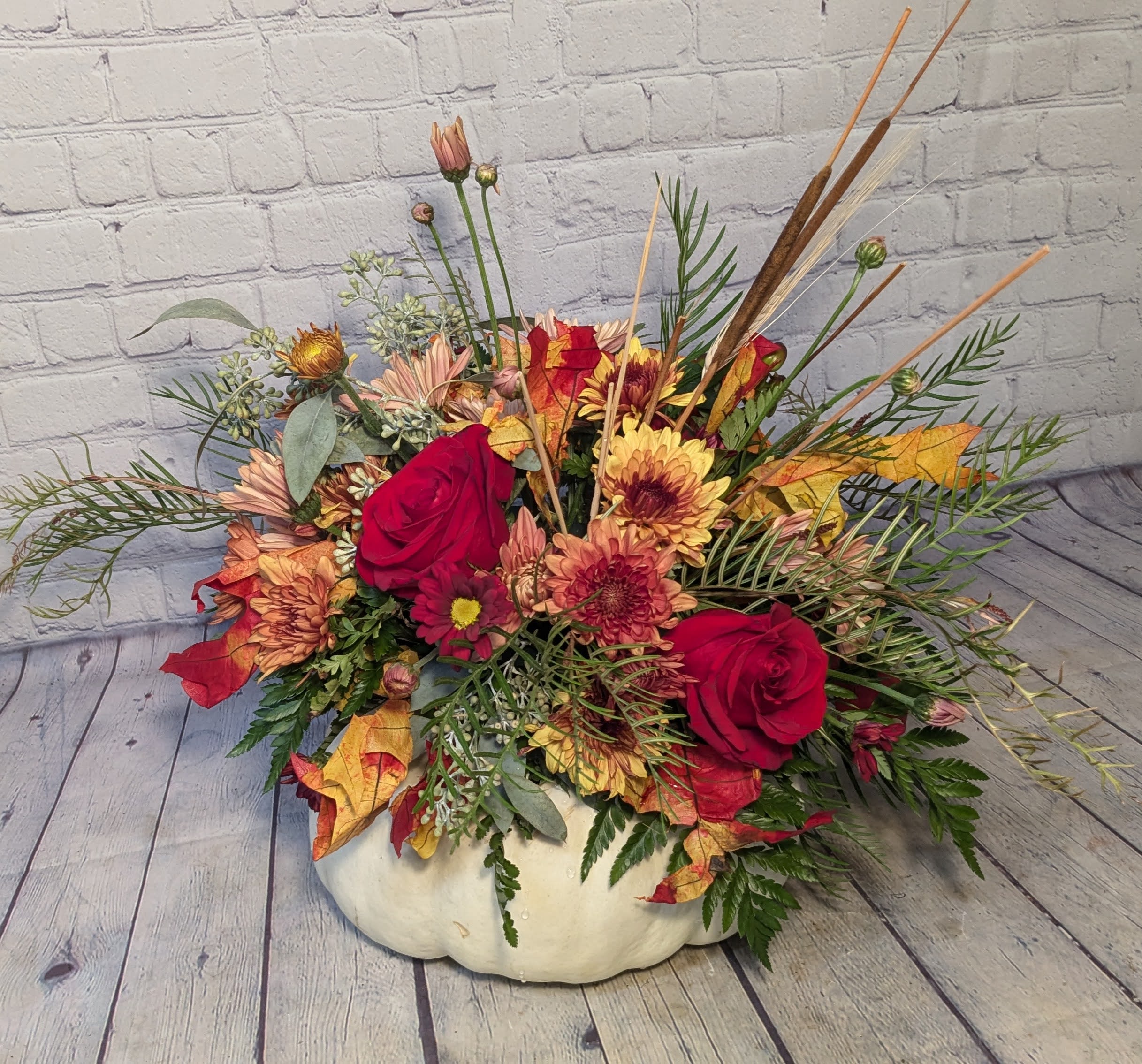 Gourdgeous  - This bouquet of flowers is arranged on top of a real locally grown pumpkin*. Flowers for this Gorgeous Gourd Bouquet may include, but are not limited to; roses, chrysanthemums, daisies, thistle, spray roses, hypericum, grivellia, seeded eucalyptus, and other fall accents. *Pumpkin color dependent upon availability (orange, white, or green)