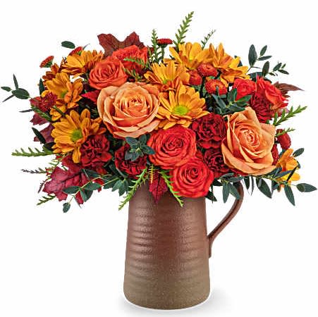 Terra Bloom Bouquet - Celebrate fall with Teleflora's Terra Bloom Bouquet, a stunning mix of autumn flowers in a rustic stoneware pitcher. With rich orange and maroon hues, this seasonal arrangement is perfect for Thanksgiving décor or a warm harvest gift