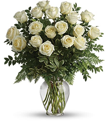One Dozen White Roses (DL) - Elevate the art of romance and elegance with our exquisite arrangement of 12 long-stem white roses. Designed to captivate the senses, each rose embodies purity, grace, and timeless beauty.  