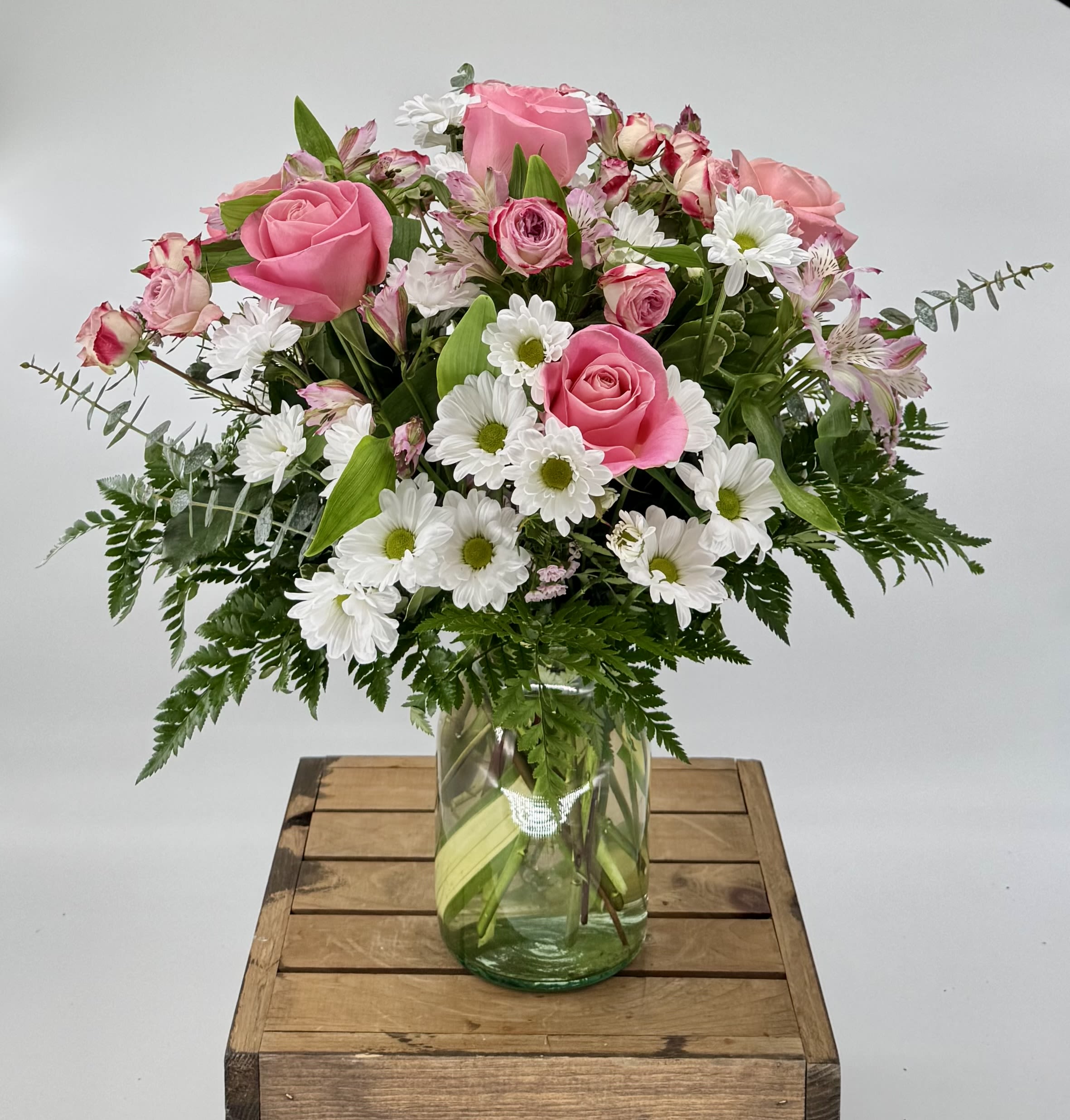 Sugar Rush (DL) - Indulge in the sweet serenity of the &quot;Sugar Rush&quot; arrangement, where delicate blooms of pink roses, white daisies, and pink carnations come together in harmonious beauty. This enchanting bouquet exudes a soft, romantic charm while invoking a sense of whimsical delight. The soft petals of the pink roses delicately blend with the cheerful white daisies and vibrant pink carnations, creating a visual symphony of color and fragrance.