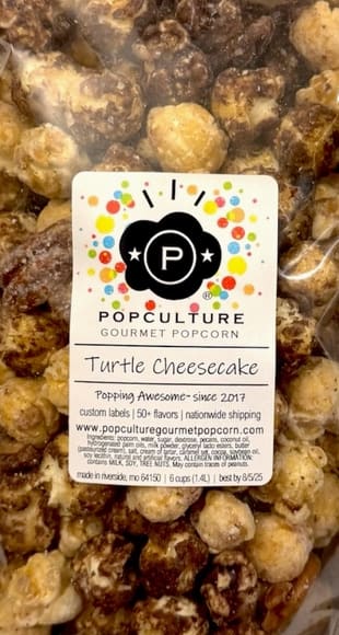 TURTLE CHEESECAKE GOURMET POPCORN TURTLE CHEESECAKE GOURMET POPCORN - Holy Moly! Handcrafted caramel cheesecake popcorn and candied pecans coated with white and dark chocolate. All the same ingredients and flavor as our original version, but now it is warm weather resistent so we can ship it all year!