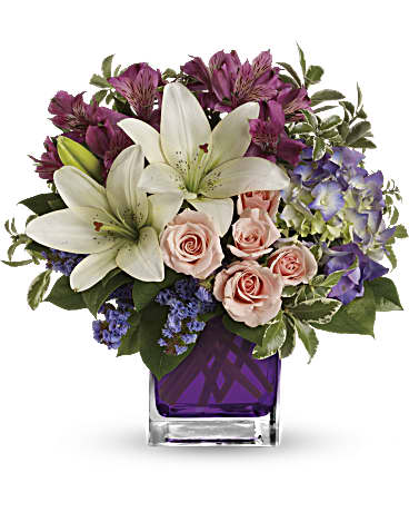 Teleflora's Garden Romance Teleflora's Garden Romance - Va-va-bloom! This stunning arrangement of purple hydrangea, light pink spray roses and white asiatic lilies is perfectly presented in our violet cube. Purple hydrangea, light pink spray roses, white asiatic lilies, dark pink alstroemeria and lavender sinuata statice are accented with assorted greens. Delivered in Teleflora's glass violet cube. Orientation: All-Around