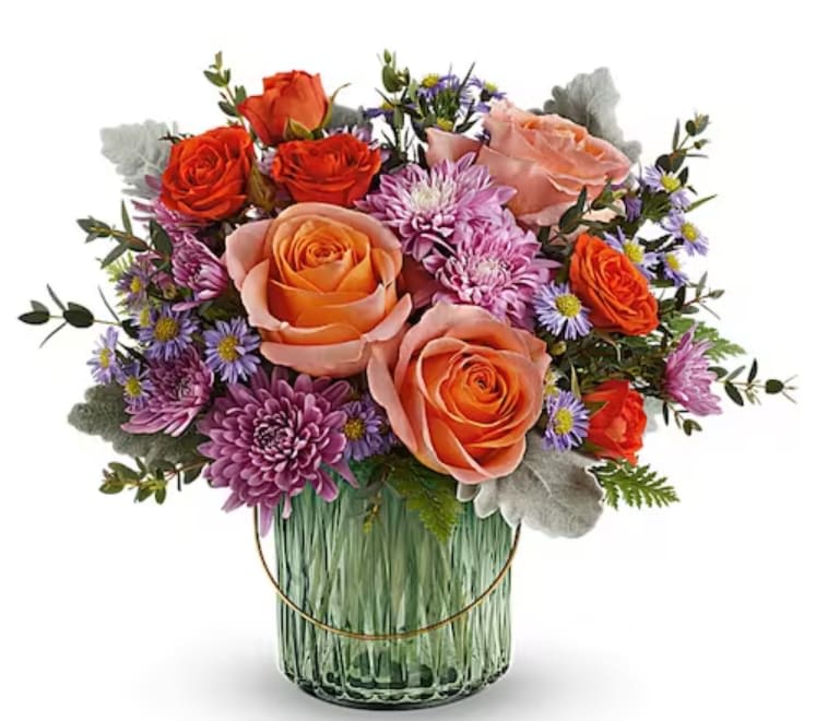 Teleflora's Pretty Blossoms Bouquet - Bursting with pretty blossoms today, glowing with a votive candle later, this delightful sage green glass lantern is a glorious gift. Peach roses, orange spray roses, lavender cushion spray chrysanthemums and small lavender monte cassino asters are accented with dusty miller, parvifolia eucalyptus and leatherleaf fern. Delivered in a Lush Garden Lantern.   Orientation : All-Around
