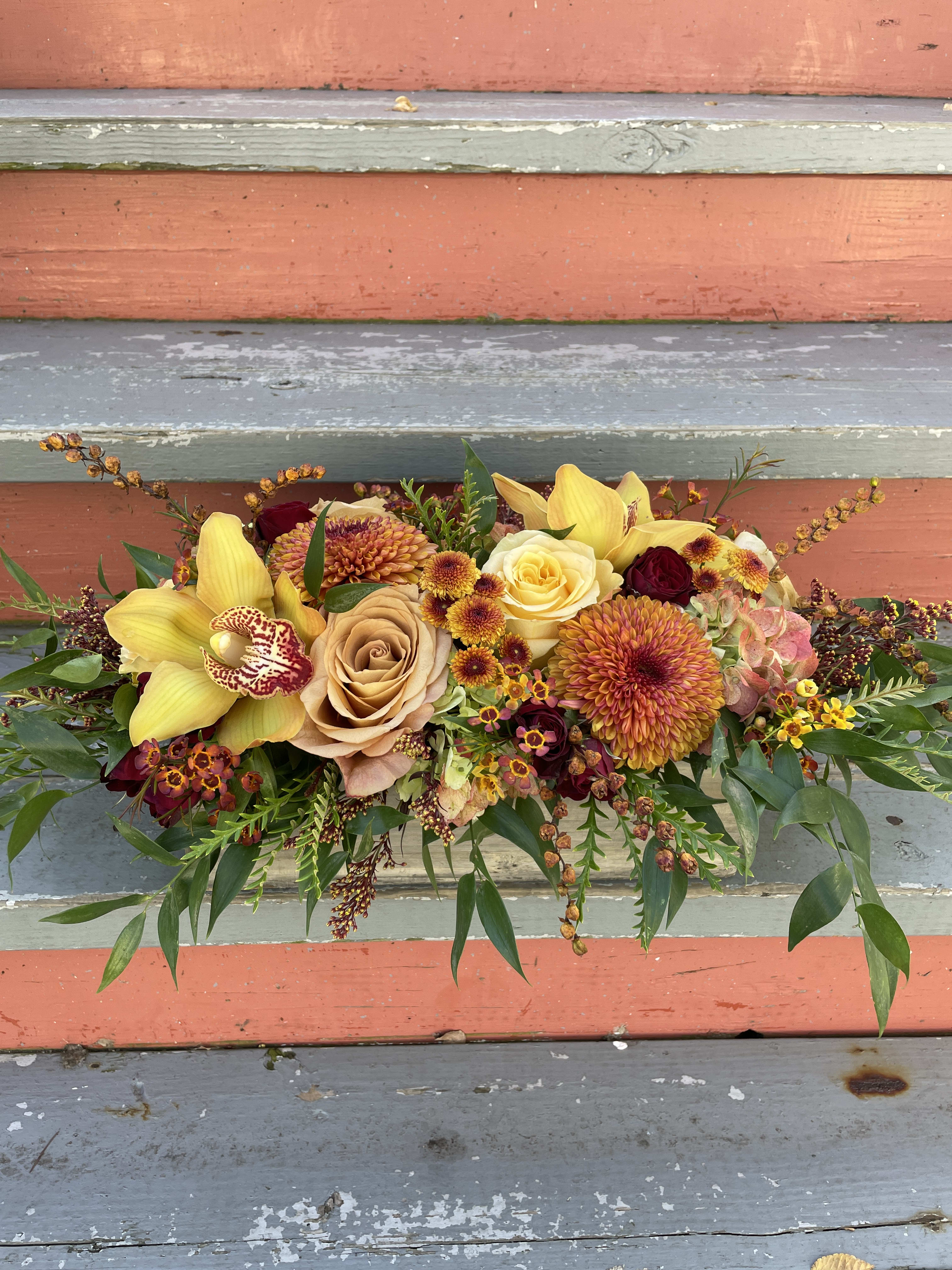 Autumn Dinner Centerpiece - A lovely long, rectangular centerpiece perfect for the dinner table and all of the seasons special gatherings! This arrangement features a lush abundance of seasonal flowers and textures in the shades of fall (rust, orange, burgundy, green and peach) Vase is a 12&quot; wooden box.