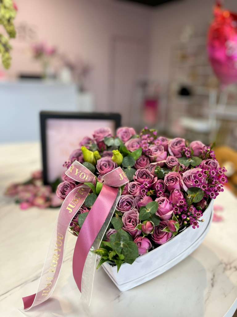 Love in Lilac - A gift full of tenderness and elegance: mini lilac roses carefully arranged in the shape of a heart, accompanied by a delicate ribbon, presented in an elegant white box. Perfect for expressing love and affection on any special occasion.  Box measurements 9.45&quot; x 7.87&quot; x 5.5&quot; 