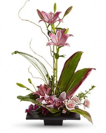 Imagination Blooms with Cymbidium Orchids - This towering topiary of asiatic lilies, orchids and roses - artistically arranged with tropical greenery - is a unique gift that celebrates the spirit of creativity. Pink asiatic lilies rise up from a square design block holding a mix of cymbidium orchids, spray roses and accent blooms and greenery.