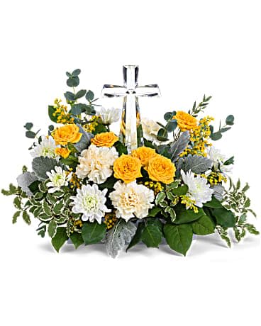 Teleflora's Be The Light Bouquet - Bring hope and light to any occasion with sunny roses and mums surrounding a glistening crystal cross keepsake. This hopeful arrangement includes yellow spray roses, light yellow carnations, white cushion spray chrysanthemums, yellow solidago, parvifolia eucalyptus, pitta negra, dusty miller and lemon leaf. Delivered with a Small Crystal Cross.