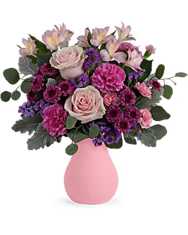 Teleflora's Cotswald Garden Bouquet - Like a walk through an English garden, this breathtaking bouquet of soft pink roses in a frosted glass vase delights and inspires. Pink roses, pink alstroemeria, purple button spray chrysanthemums, hot pink carnations and lavender sinuata statice are arranged with dusty miller and silver dollar eucalyptus. Delivered in Teleflora's Serendipity Glass Vase.