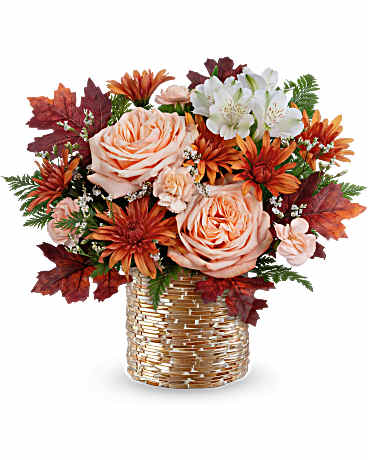 Teleflora's Sparkling Blooms Bouquet - Sparkling Blooms Bouquet glows with autumn beauty. Warm peach roses and fall blooms shine in a golden mosaic vase-perfect for Thanksgiving gatherings, seasonal gifts, or cozy home dÃ©cor. Sparkling Blooms Bouquet features peach roses, white alstroemeria, peach miniature carnations, bronze cushion spray chrysanthemums, and white limonium. Accented with leatherleaf fern and preserved oak leaves in a golden mosaic vase.
