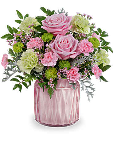 Teleflora's Sparkling Reverie Bouquet - Brighten any moment with the Dazzling Gem jar, its soft pearlescent shimmer perfectly complementing a delicate bouquet of soft pink and green blooms-a timeless expression of artistic beauty for any occasion. The Sparkling Reverie Bouquet features a charming blend of pink roses, green carnations, pink miniature carnations, green button spray chrysanthemums, pink waxflower, silver lace dusty miller, huckleberry, and leatherleaf fern. Arranged in a pink pearlescent vase, this elegant bouquet adds a touch of timeless beauty to any space.